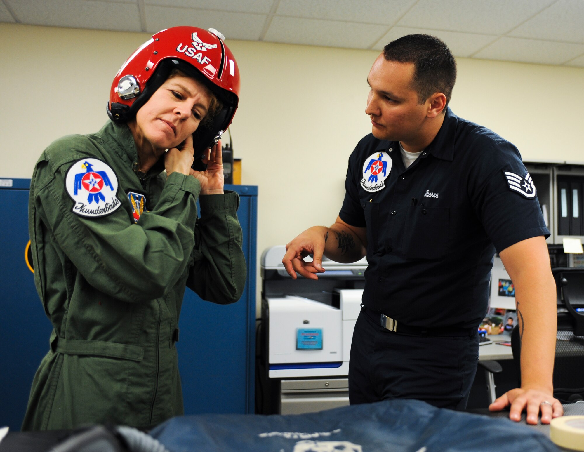 Jeannette Mare, founder and executive director of Ben’s Bells Project, dawns her helmet before a Hometown Hero Flight at Davis-Monthan Air Force Base, Ariz., April 10, 2014. Mare received the Hometown Hero Award for the resilience she displayed following a personal tragedy. (U.S. Air Force photo by Senior Airman Sivan Veazie/Released)