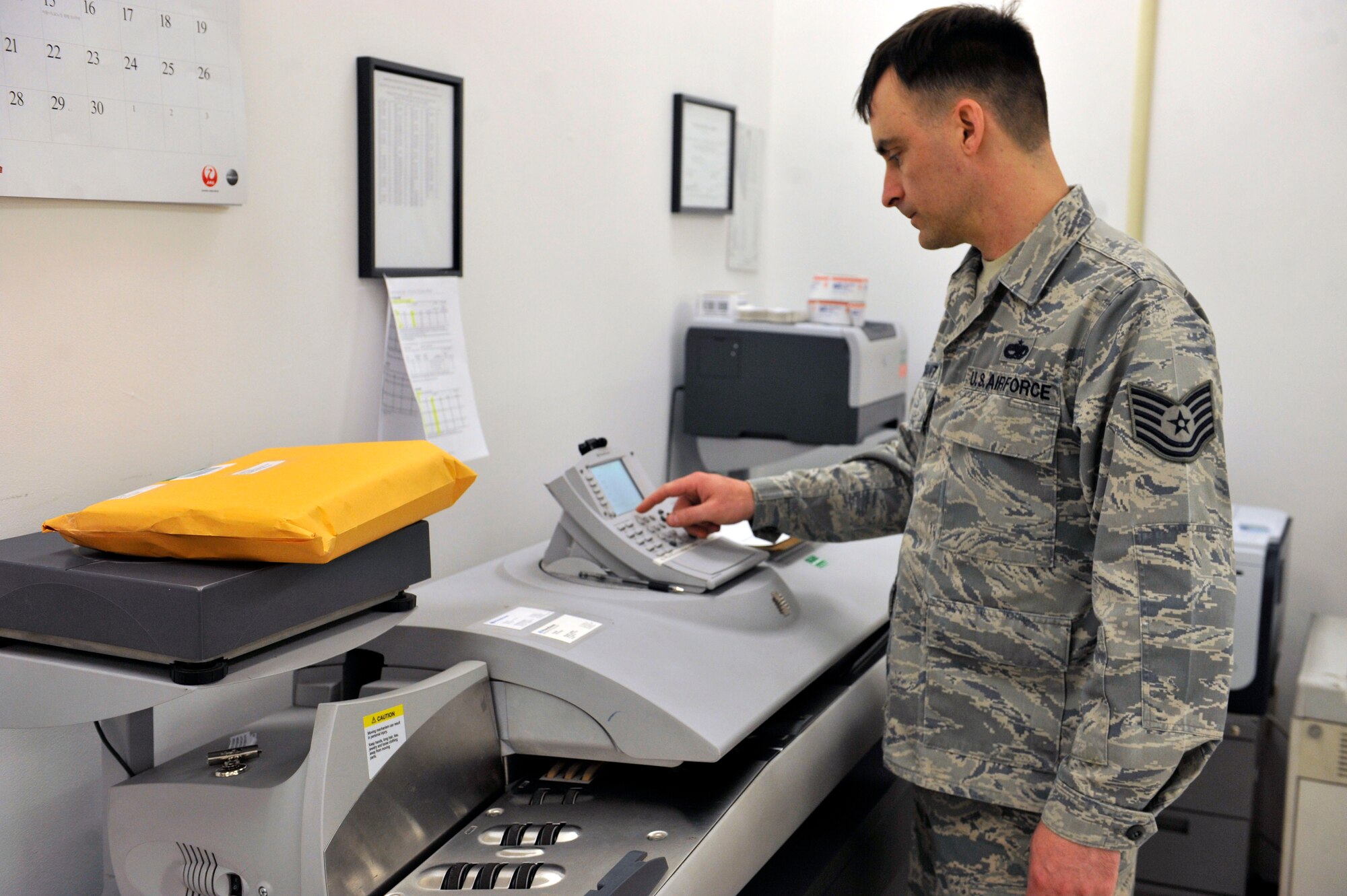 Tech. Sgt. Jerry Prowant, 51st Communication Squadron official mail manager, selects the proper way to send a package before printing the postage to place on the package April 10, 2014 at the post office at Osan Air Base, Republic of Korea. The post office received an outstanding in each of the four sections during the inspection. (U.S. Air Force photo by Senior Airman David Owsianka)
