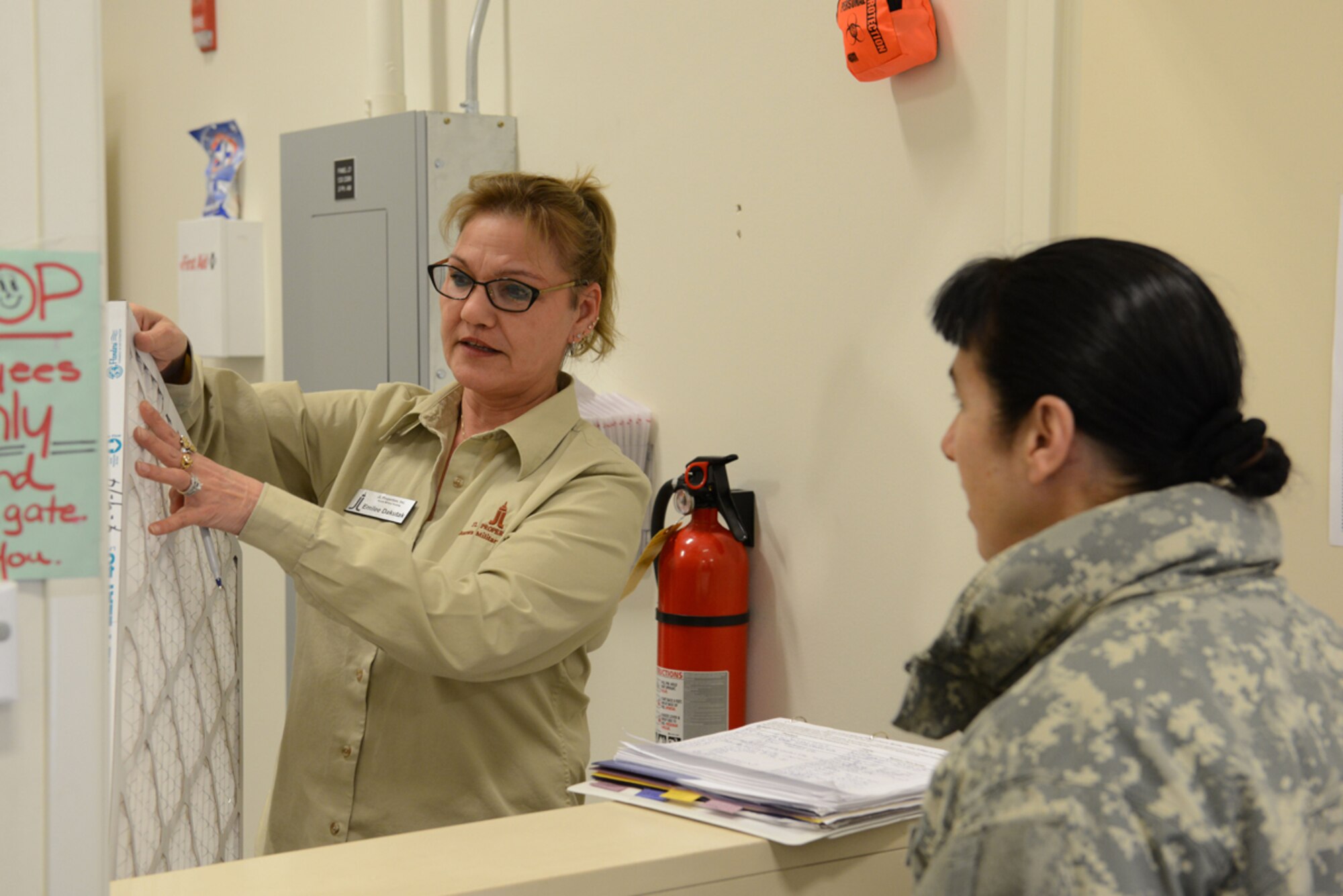 Emilee Dakutak, Joint Base Elmendorf-Richardson U-Fix-It Clerk, explains the air filter replacement process to Army Staff Sgt. Catherine Spillane, Warrior Transition Battalion S3 Operations Non-commissioned officer at the JBER-Elmendorf U-Fix-It shop here April 10, 2014. The U-Fix-It shops on JBER provide many tools and supplies to assist base residents in self-repairs. (U.S. Air Force photo/Senior Airman Austin Willhoit)