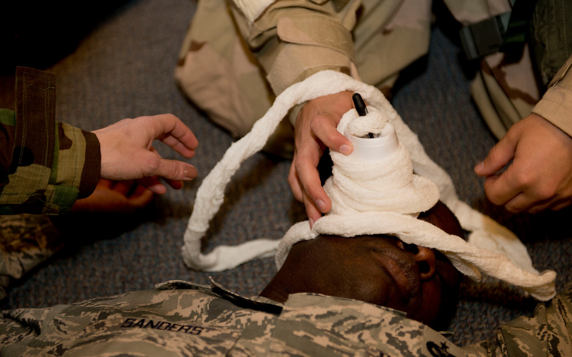 Staff Sgt. Carlos Sanders, 366th Contracting Squadron contracting officer, simulates an eye injury during Sharpshooter 14-02 exercise April 15, 2014, Mountain Home Air Force Base, Idaho. Airmen are expected to respond quickly to the scenarios given by the Wing Inspection Teams. (U.S. Air Force photo by Airman 1st Class Malissa Lott)  