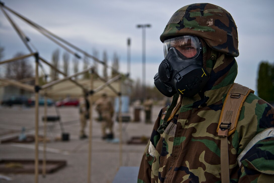 Senior Airman Ryan Gramlich, Contamination Control Area personnel, supervises simulated decontamination proceedures during the Sharpshooter 14-02 exercise April 15, 2014, Mountain Home Air Force Base, Idaho. When Airmen’s gear is contaminated, they are guided through a series of stations in the CCA. (U.S. Air Force photo by Airman 1st Class Malissa Lott) 