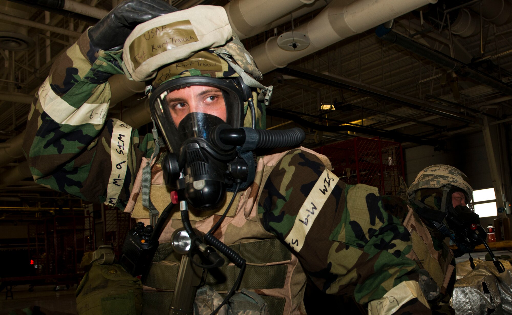 Tech. Sgt. Kurt Trauch, 366th Civil Engineer Squadron firefighter, practices donning his chemical gear during the weeklong Sharpshooter 14-02 exercise April 15, 2014, Mountain Home Air Force Base, Idaho. (U.S. Air Force photo by Airman 1st Class Malissa Lott)