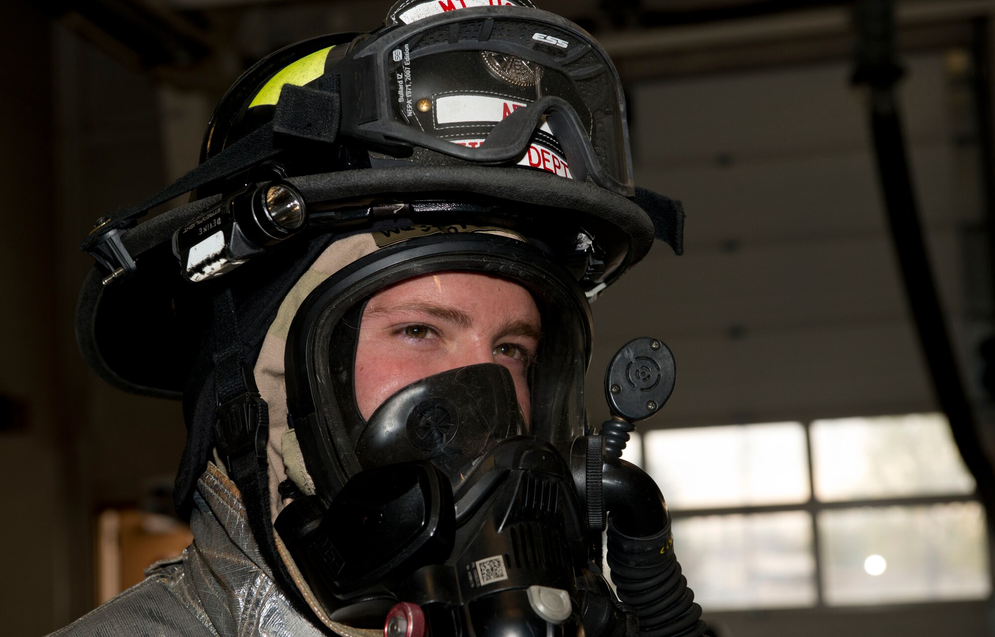 Senior Airman Westine Devine, 366th Civil Engineer Squadron firefighter, stands in full firefighter mission-oriented protective posture gear before operations during the Sharpshooter 14-02 exercise April 15, 2014, Mountain Home Air Force Base, Idaho. Firefighters must wear normal chemical gear as well as fire retardant gear when responding to fires in a chemical environment. (U.S. Air Force photo by Airman 1st Class Malissa Lott) 