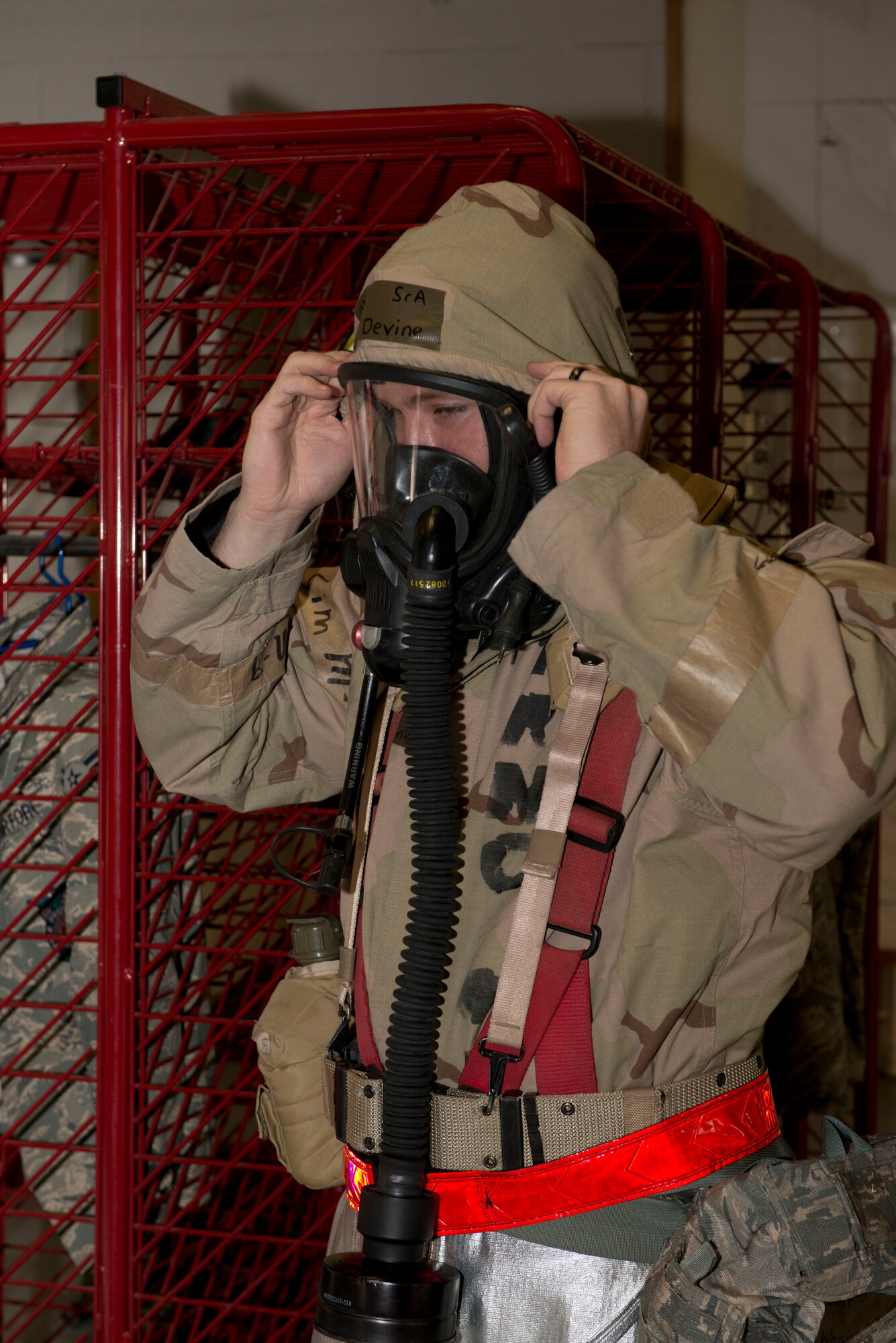 Staff Sgt. Chris Palkowetz, 366th Civil Engineer Squadron firefighter, dons his mission-oriented protective posture gear during Sharpshooter 14-02 exercise April 15, 2014, Mountain Home Air Force Base, Idaho. Firefighters must wear normal chemical gear as well as wearing fire retardant gear when responding to fires in a chemical environment. (U.S. Air Force photo by Airman 1st Class Malissa Lott) 