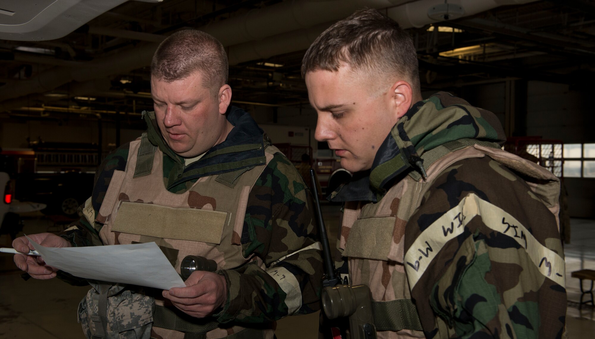 Tech. Sgt. Jack Pyle and Tech. Sgt. Kurt Trauch, 366th Civil Engineer Squadron firefighters, look over operations briefs during the Sharpshooter 14-02 exercise April 15, 2014, Mountain Home Air Force Base, Idaho. While practicing war-time scenarios, Airmen are tested with a series of injects from Wing Inspection Teams.  (U.S. Air Force photo by Airman 1st Class Malissa Lott)