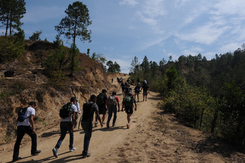 More than 130 members of Joint Task Force-Bravo completed a 6.2 mile round trip hike to deliver more than 3,000 pounds of food and supplies to families in need in the mountain village of Picacho, Honduras, April 12, 2014. During the more than three mile trek up the mountain, Task Force members made an elevation gain of 1,600 feet while carrying more than 25 pounds of supplies each. The food and supplies were all purchased with donations made by the members of Joint Task Force-Bravo. (Photo by U. S. Air National Guard Capt. Steven Stubbs)