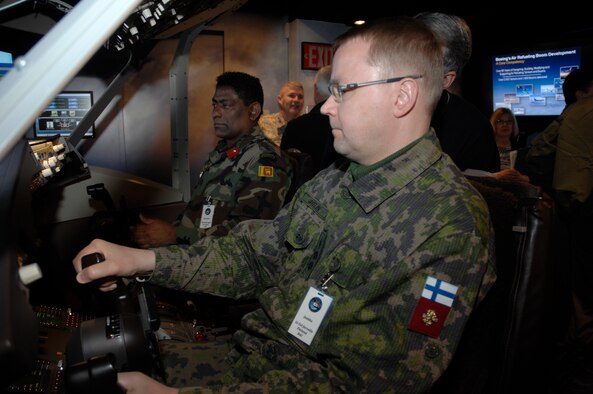 Finland's Lt. Col. Jaakko Jurvelin (foreground) and Sri Lanka's Col. Harendra Ranasinghe "pilot" the KC-46 simulator during a stop along their tour of Wright-Patterson Air Force Base April 7.