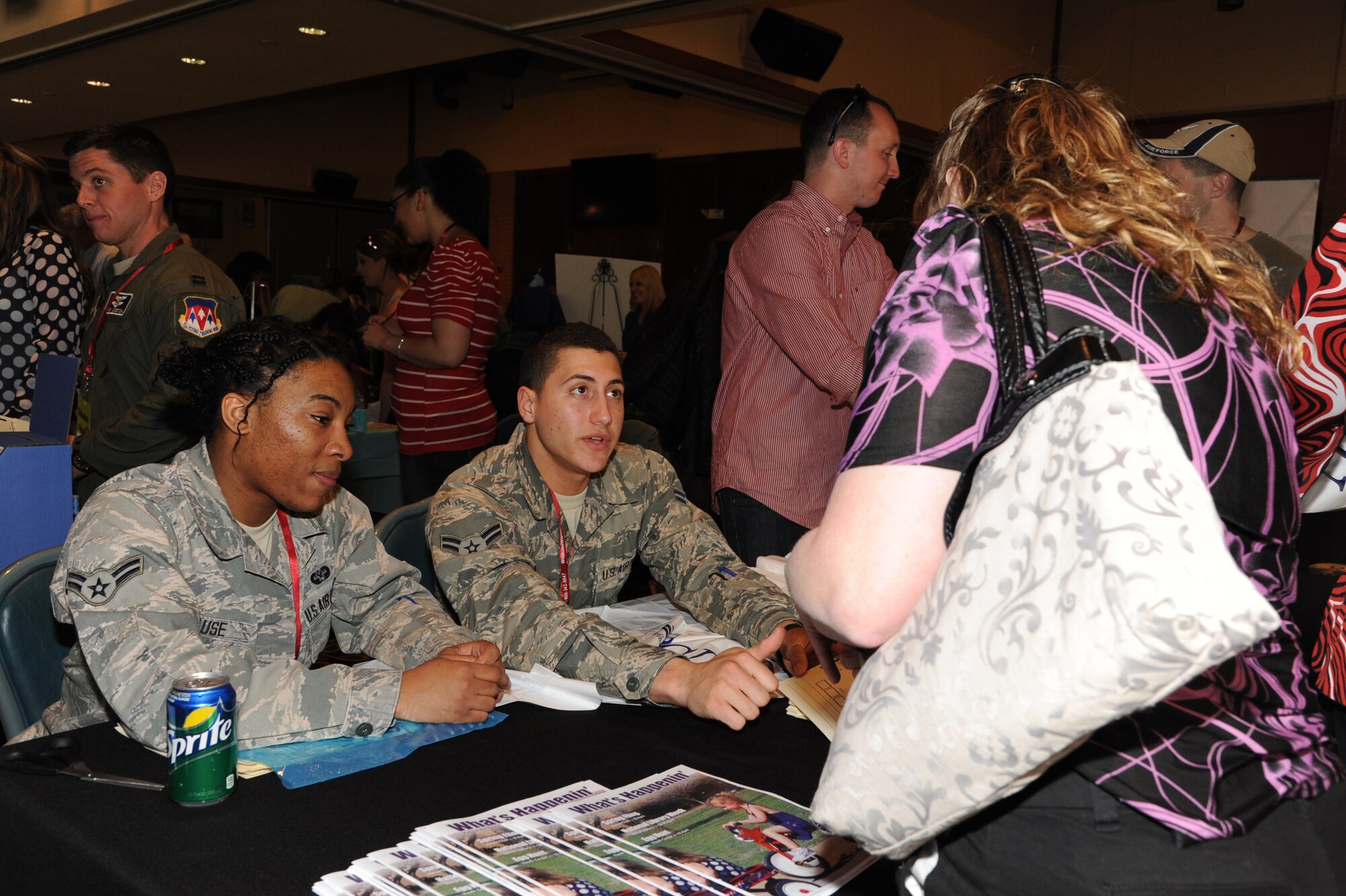 Airmen 1st Class Shafiquca Gause, a 71st Flying Training Wing Judge Advocate Office paralegal, and Eduardo Garcia-Santiago, a 71st Comptroller Squadron customer service technician, give an overview of the events to attendees before they set out on their own at Vance’s Annual Spring Fling held in the club April 8. During Spring Fling, vendors from the local community and representatives from different services on base, set up booths to talk with attendees about the services they offer. This year, attendees enjoyed free sloppy joes during the event. (U.S. Air Force photo/Senior Airman Frank Casciotta)