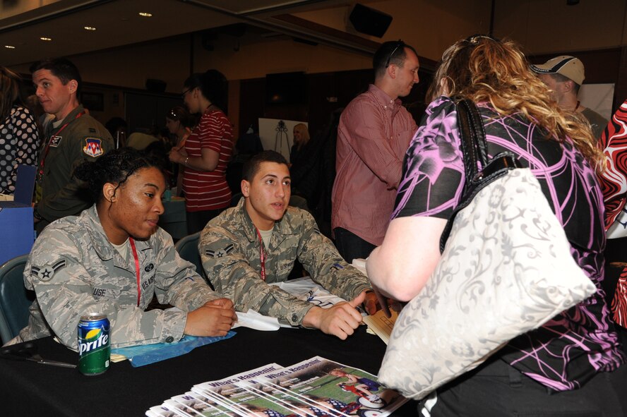 Airmen 1st Class Shafiquca Gause, a 71st Flying Training Wing Judge Advocate Office paralegal, and Eduardo Garcia-Santiago, a 71st Comptroller Squadron customer service technician, give an overview of the events to attendees before they set out on their own at Vance’s Annual Spring Fling held in the club April 8. During Spring Fling, vendors from the local community and representatives from different services on base, set up booths to talk with attendees about the services they offer. This year, attendees enjoyed free sloppy joes during the event. (U.S. Air Force photo/Senior Airman Frank Casciotta)