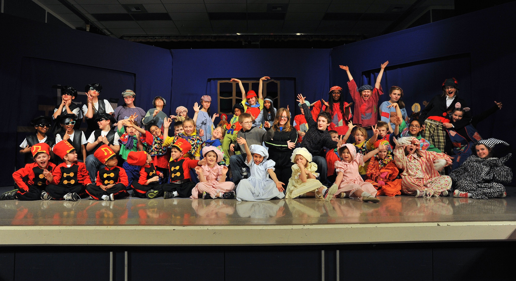 The cast of “Pinocchio” takes a bow after their dress rehearsal April 11, 2014, at Michael Andersen elementary School. The Missoula Children’s Theater members travel in pairs around the world visiting military bases, schools, summer camps and more, spending a week at each location to cast, practice and perform various plays. (U.S. Air Force photo by Staff Sgt. Veronica Montes/released)