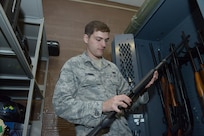 Air Force Staff Sgt. Benjamin Dunning, 902nd Security Forces Squadron Armory NCO in Charge, takes inventory of privately owned weapons April 11 at Joint Base San Antonio-Randolph.  (U.S. Air Force photo by Joel Martinez)

