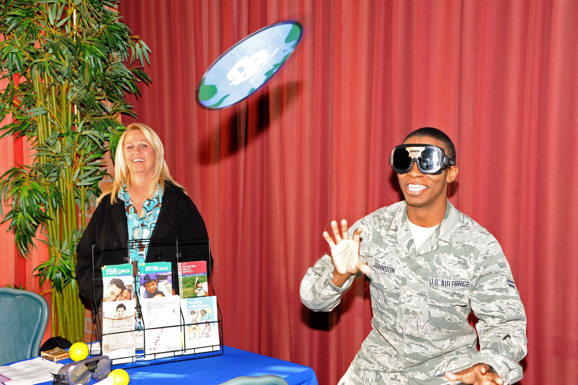 Airman 1st Class Daquan Johnson, a 71st Medical Operations Squadron flight medicine technician, attempts to catch a flying disk while wearing “drunk goggles” at Vance’s Annual Spring Fling held in the club April 8. During Spring Fling, vendors from the local community and representatives from different services on base, set up booths to talk with attendees about the services they offer. The drunk goggles simulate how vision is impaired while a person is intoxicated and their purpose is to demonstrate the lack of control someone experiences while driving drunk. This year, attendees enjoyed free sloppy joes during the event. (U.S. Air Force photo/Senior Airman Frank Casciotta)