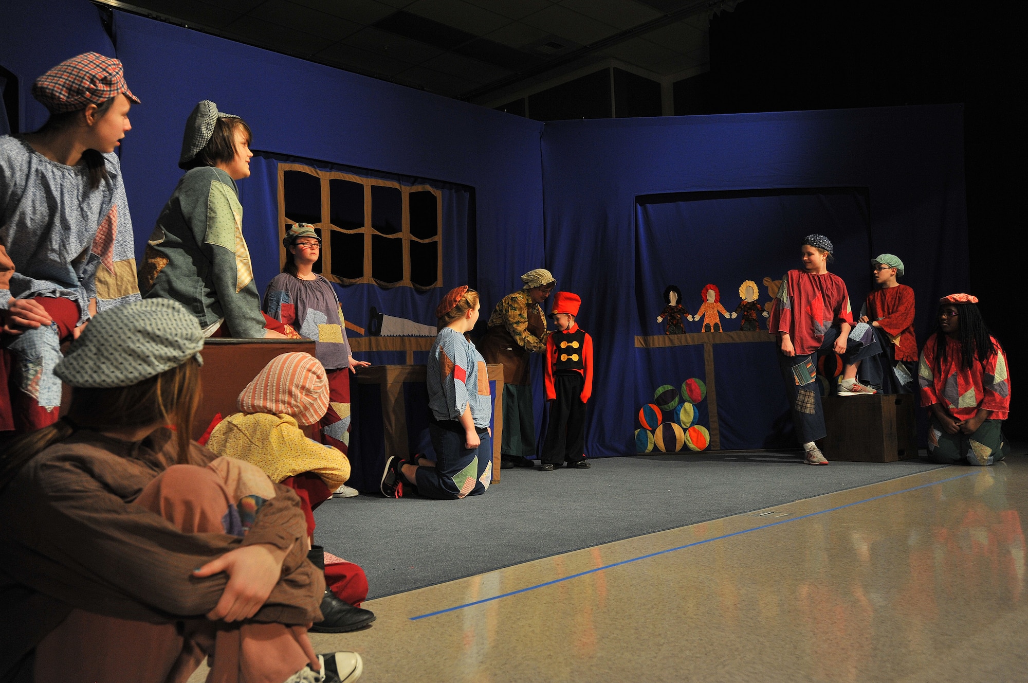 Members from Missoula Children’s Theater join Fairchild youth in the production of “Pinocchio” April 11, 2014, at Michael Andersen Elementary School. The Missoula Children’s Theater members travel in pairs around the world visiting military bases, schools, summer camps and more, spending a week at each location to cast, practice and perform various plays. (U.S. Air Force photo by Staff Sgt. Veronica Montes/released)