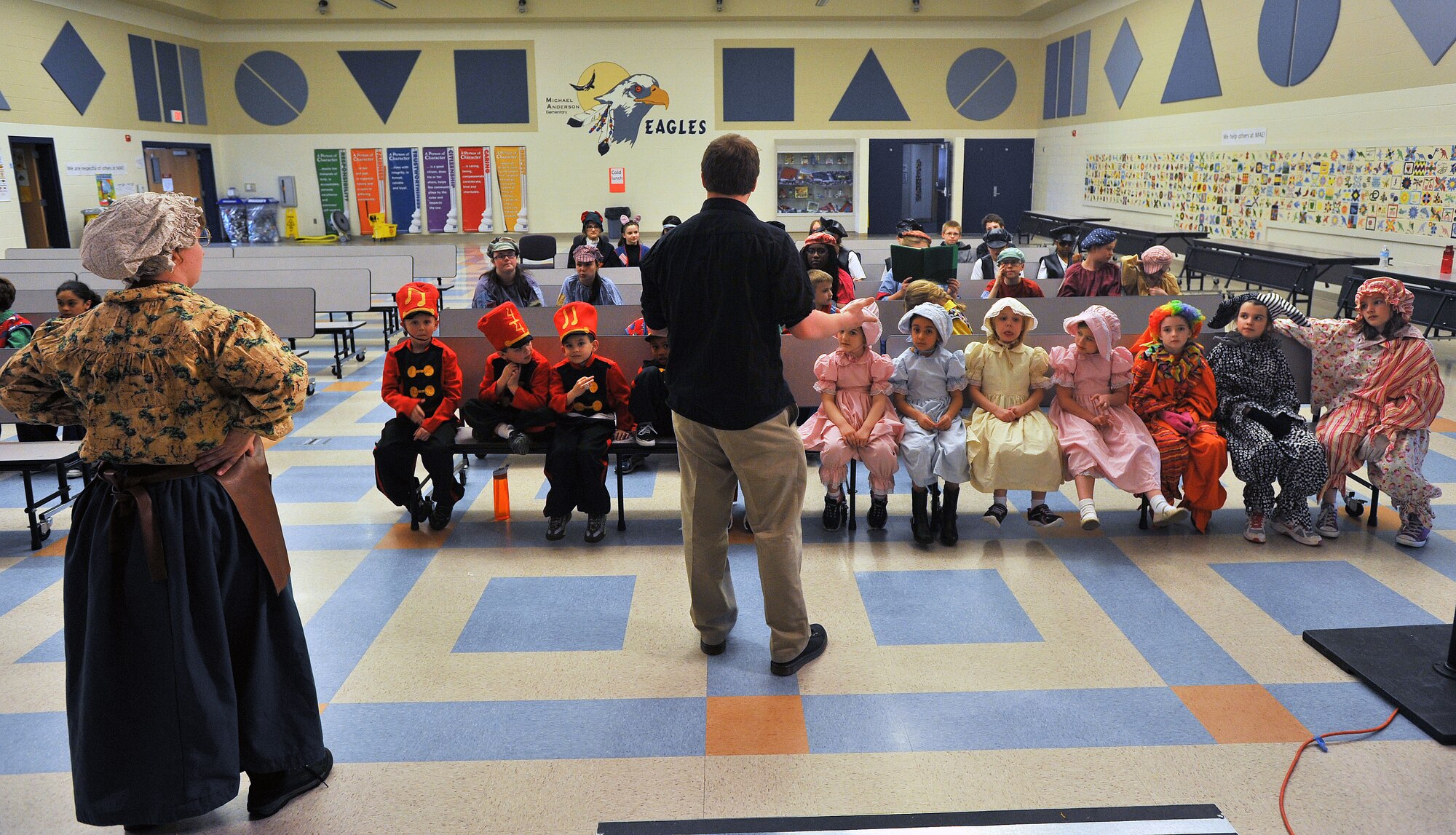 Ted Drury, Missoula Children’s Theater tour actor director, talks with Fairchild youth before their dress rehearsal for “Pinocchio” April 11, 2014, at Michael Andersen Elementary School. Forty two children from ages 5 to 16 were part of this year’s production. (U.S. Air Force photo by Staff Sgt. Veronica Montes/Released)