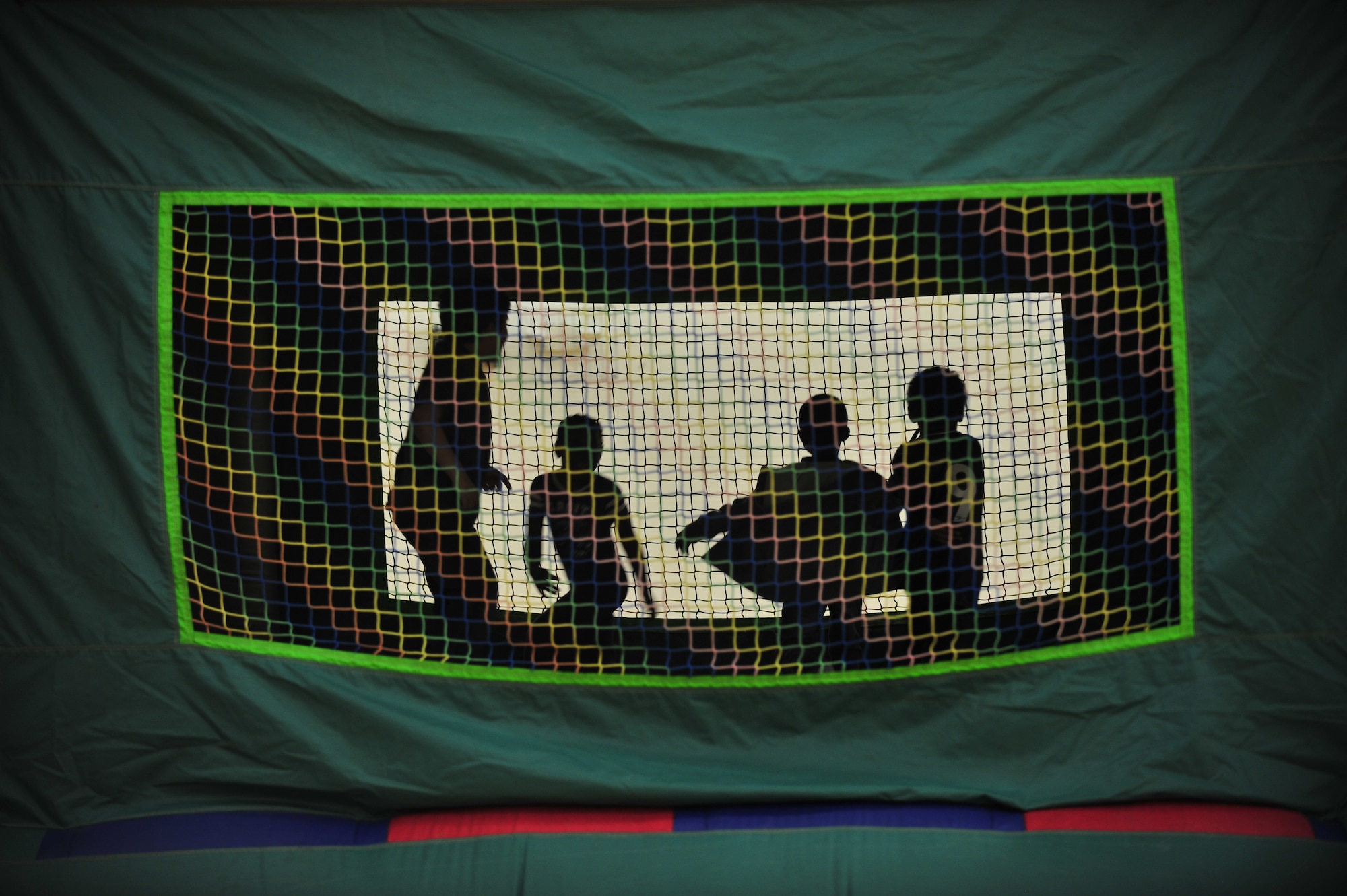 Children jump in a bounce house during a deployed spouses dinner at the Youth Center April 10, 2014, at Dover Air Force Base, Del. The 436th Medical Group hosted the dinner and other activities for the spouses and children of deployed Team Dover members. (U.S. Air Force photo/Staff Sgt. Elizabeth Morris)