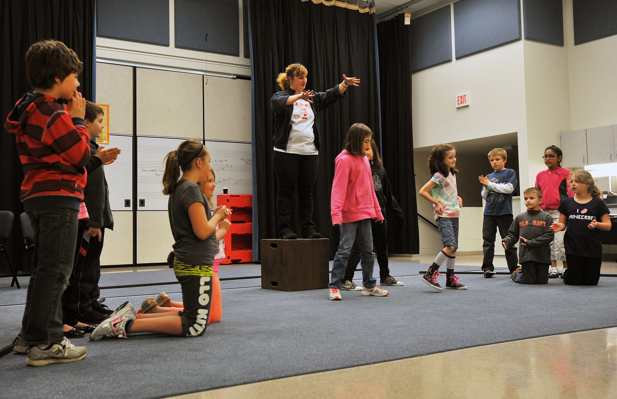 Morgan Maul-Smith, Missoula Children’s Theater tour actor director, works with Fairchild youth during practice for the play “Pinocchio” April 9, 2014, at Michael Andersen Elementary School.  The Missoula Children’s Theater members travel in pairs around the world visiting military bases, schools, summer camps and more, spending a week at each location to cast, practice and perform various plays. (U.S. Air Force photo by Staff Sgt. Veronica Montes/released)