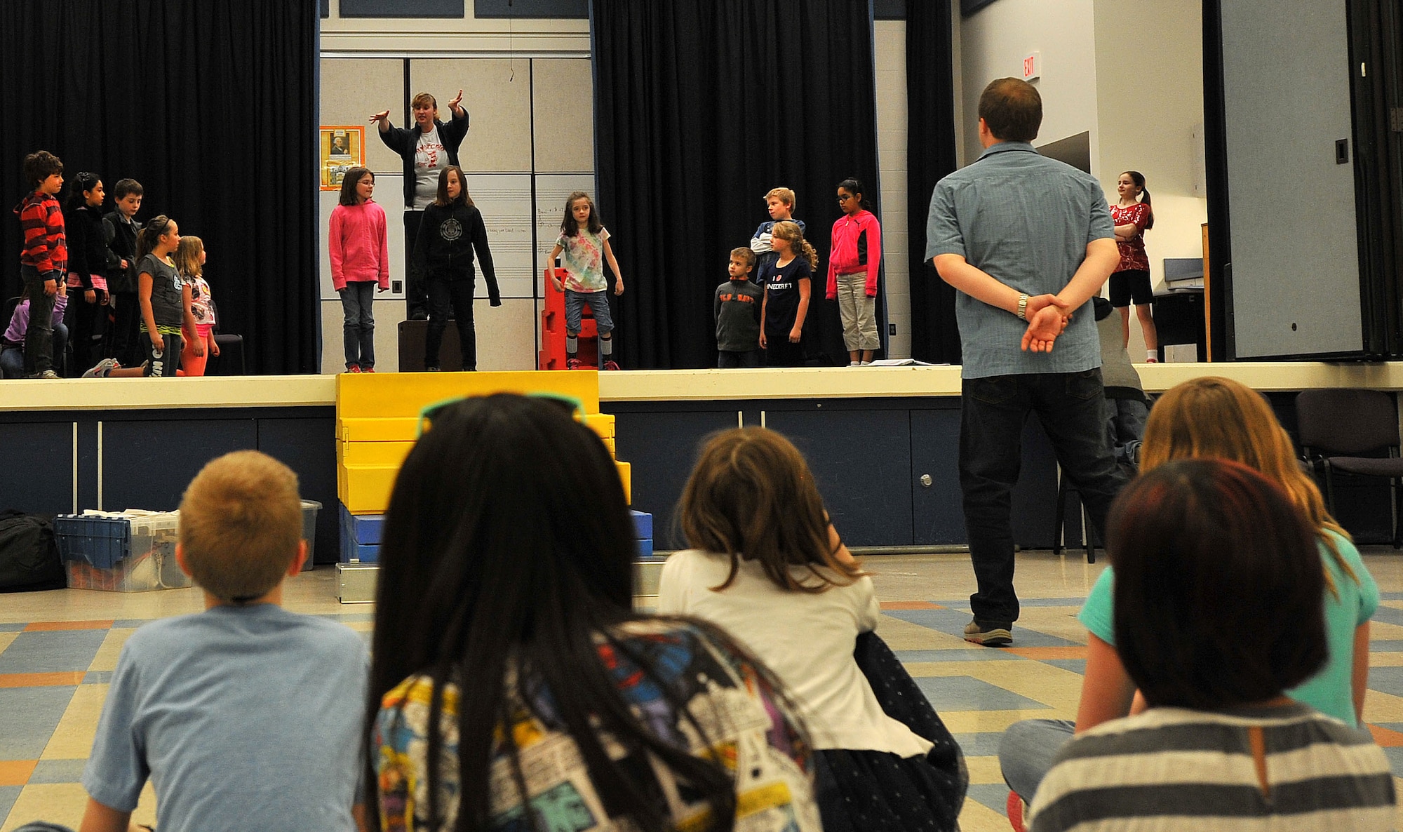 Members from the Missoula Children’s Theater work with Fairchild youth during practice for the play “Pinocchio” April 9, 2014, at Michael Andersen Elementary School.  The Missoula Children’s Theater members travel in pairs around the world visiting military bases, schools, summer camps and more, spending a week at each location to cast, practice and perform various plays. (U.S. Air Force photo by Staff Sgt. Veronica Montes/released)
