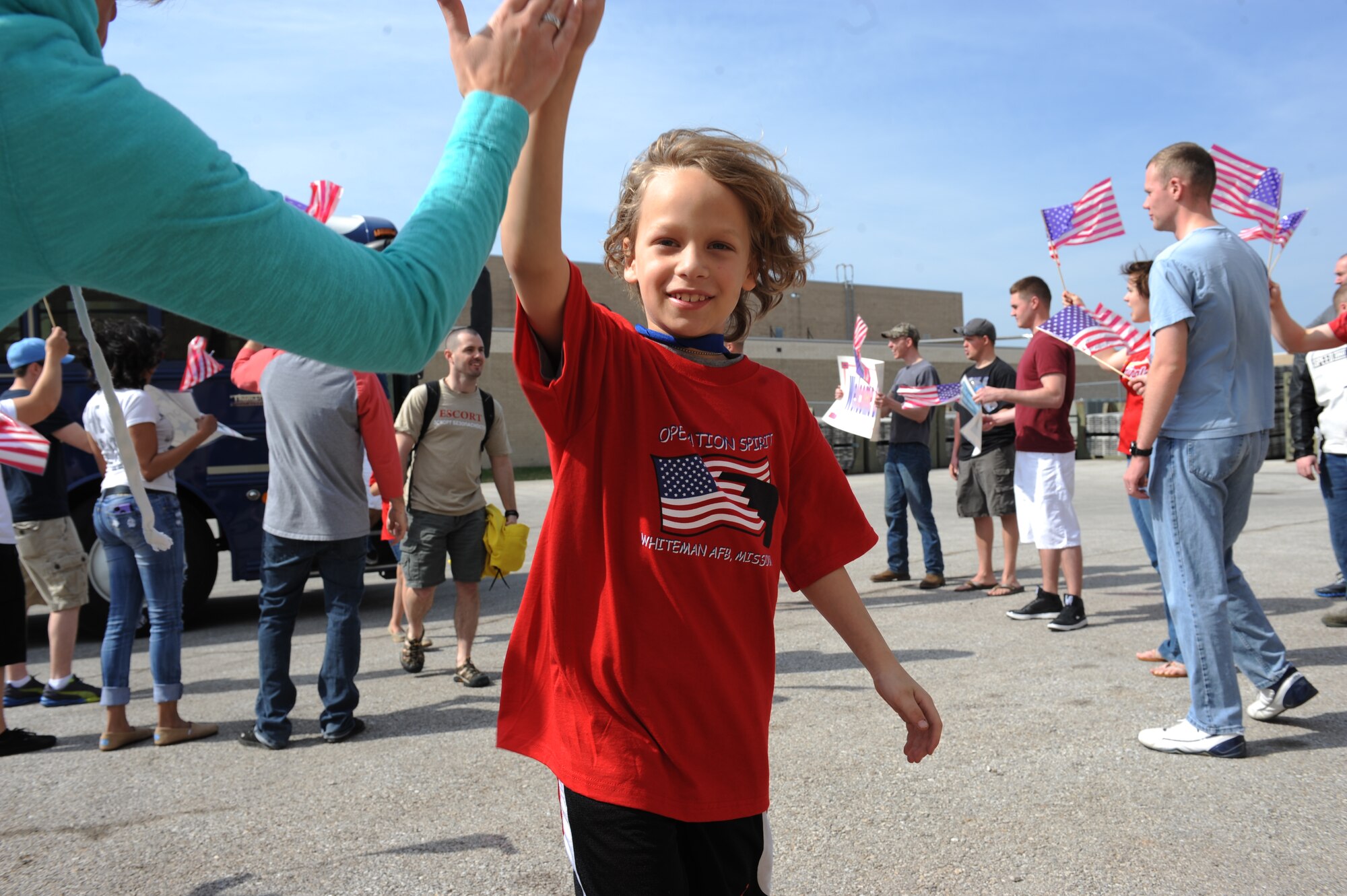 An Operation Spirit “deployer” is welcomed home following his mock deployment during Operation Spirit at Whiteman Air Force Base, Mo., April 12, 2014. For their “deployment” children were issued an Operation Spirit T-shirt, an identification card and dog tags as part of their deployment kits. (U.S. Air Force photo/Airman 1st Class Joel Pfiester/Released)