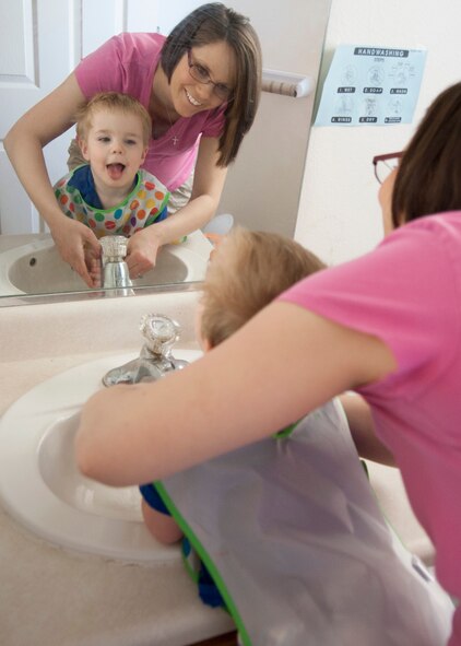 Tiffany Heppler, family child care provider, and Elijah, her son, wash their hands after craft timeApril 11, 2014,in base housing on Dover Air Force Base, Del. Heppler enjoys being a provider because she can helpout other families by providing childcare. (U.S. Air Force photo/Senior Airman Jared Duhon)  