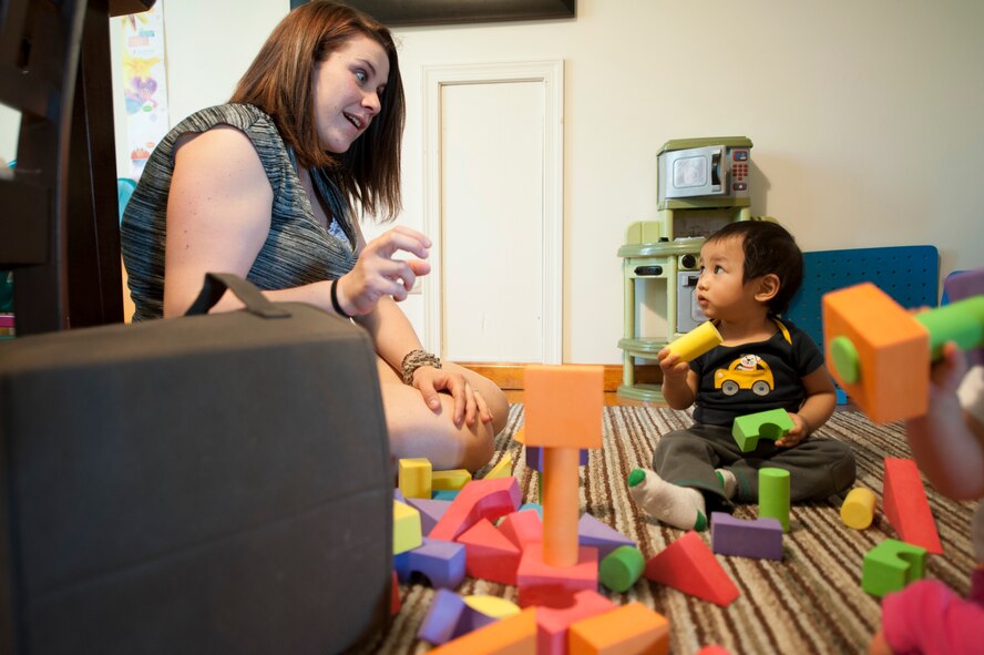During playtime Kristin Warat, family child care provider, and Paul, one of the children she cares for, build towers April 11, 2014,at her house in Little Creek, Del. Warat has been a provider for two years. (U.S. Air Force photo/Senior Airman Jared Duhon) 