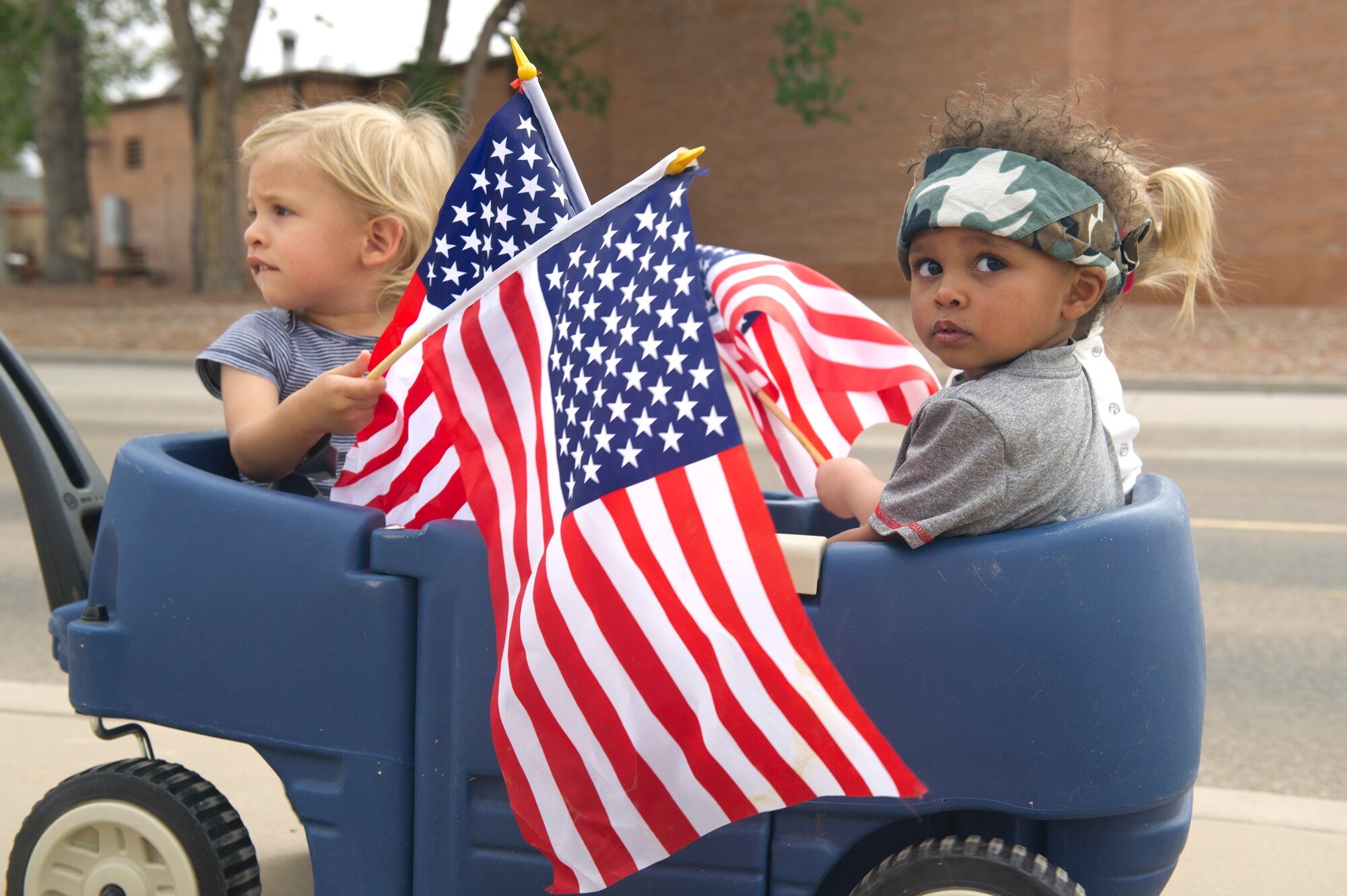 Members of Team Holloman dependents participate in a parade at Holloman Air Force Base N.M., April 11.  April is recognized the Month of the Military Child, created by Secretary of Defense Caspar W. Weinberger in 1986.  This month highlights the contribution that military children make as their parent or parents serve our nation.  It is during April of each year that all branches of services provide special days and events to honor military children. (U.S. Air Force photo by Staff Sgt. Warren Spearman / Released) 