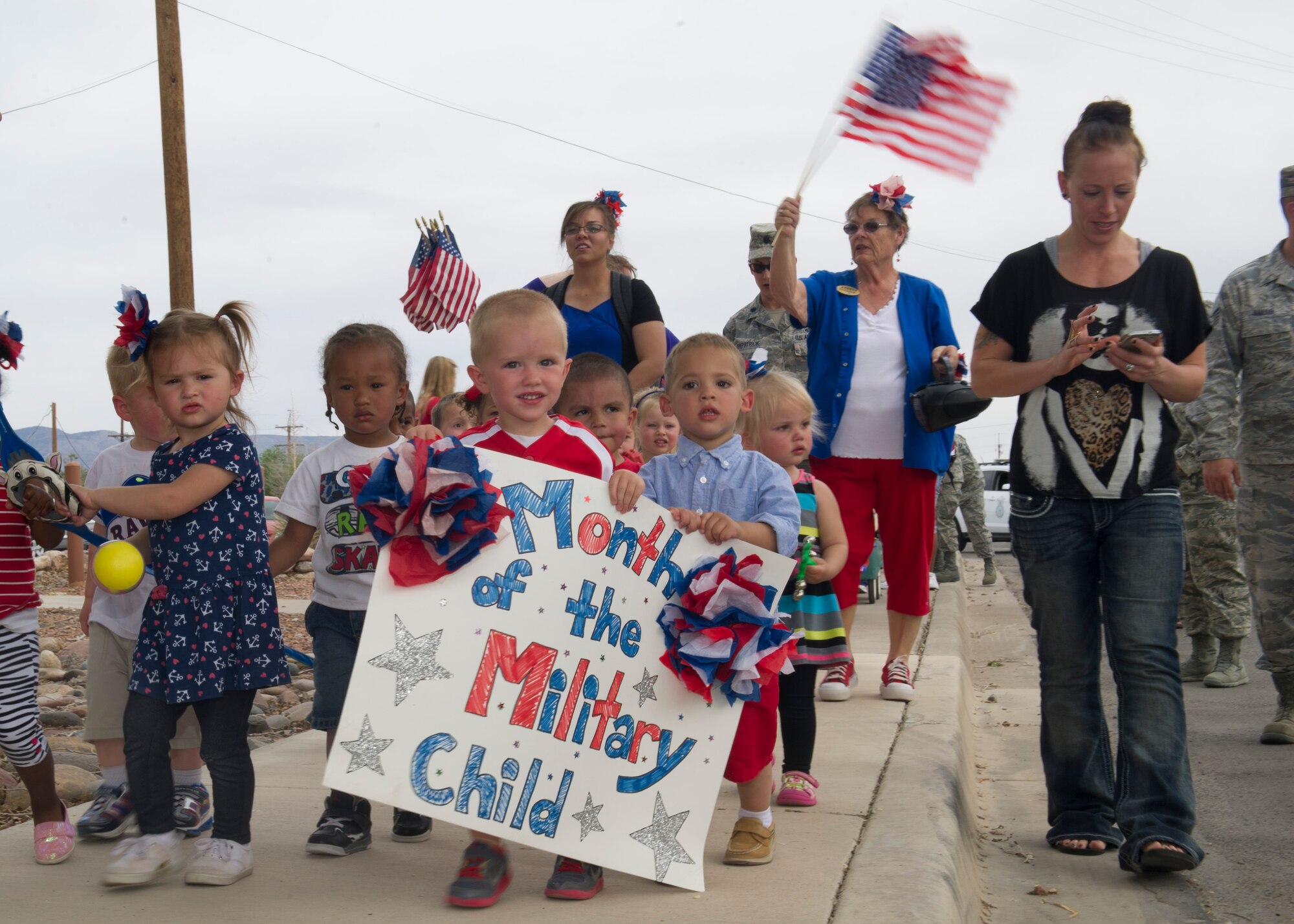 Members of Team Holloman dependents participate in a parade at Holloman Air Force Base N.M., April 11.  April is recognized the Month of the Military Child, created by Secretary of Defense Caspar W. Weinberger in 1986.  This month highlights the contribution that military children make as their parent or parents serve our nation.  It is during April of each year that all branches of services provide special days and events to honor military children. (U.S. Air Force photo by Staff Sgt. Warren Spearman / Released) 