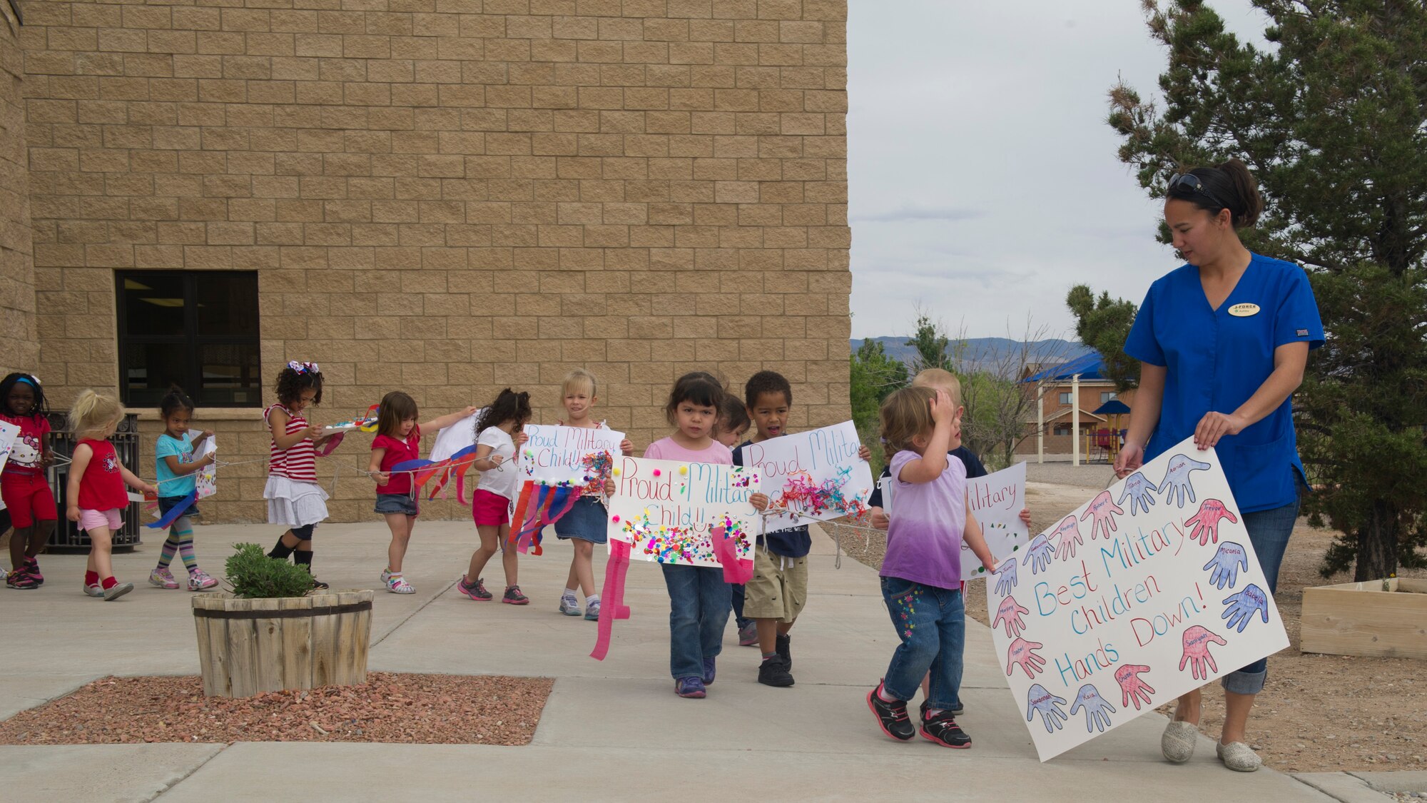 Members of Team Holloman dependents participate in a parade at Holloman Air Force Base N.M., April 11.  April is recognized the Month of the Military Child, created by Secretary of Defense Caspar W. Weinberger in 1986.  This month highlights the contribution that military children make as their parent or parents serve our nation.  It is during April of each year that all branches of services provide special days and events to honor military children. (U.S. Air Force photo by Staff Sgt. Warren Spearman / Released) 