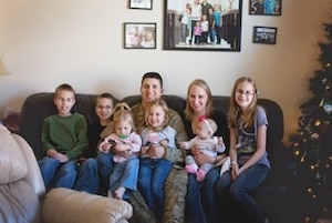 Master Sgt. Zachery Mleko, Air Reserve Personnel Center system requirements analyst, and his wife Jamie Mleko, spend time with their children upon his return from deployment in December, 2013. (Courtesy photo)