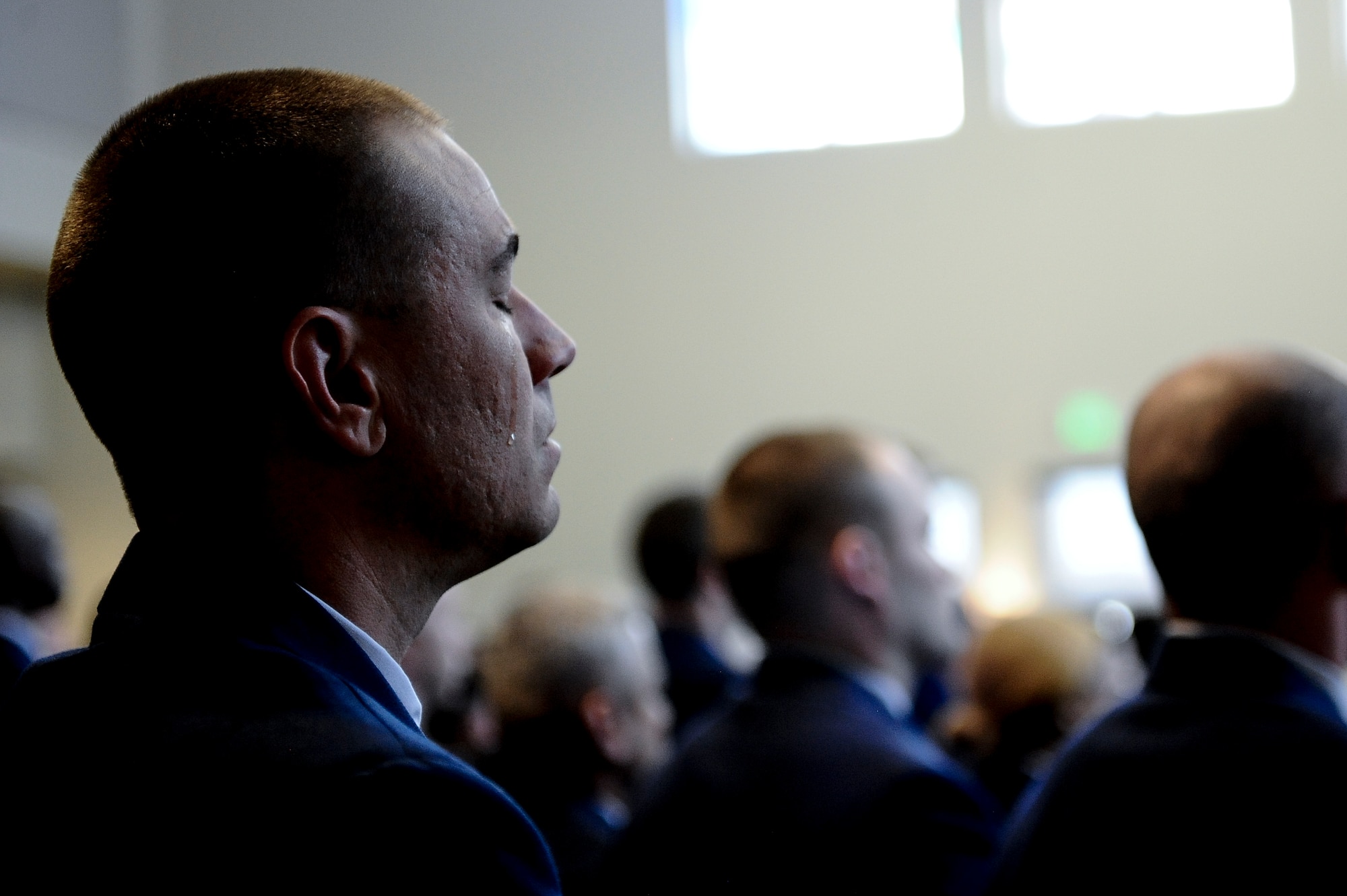 Staff Sgt. Kyle Stockman, 460th Space Communications Squadron, sheds a tear during a memorial service for Senior Airman Michael S. Snyder, 460th SCS cyber transport journeyman, April 14, 2014, at the base chapel on Buckley Air Force Base, Colo. Snyder, an El Paso, Ill. native, was 23 years old and had been at Buckley for two years before he was killed by an alleged drunk driver while on his motorcycle the night of April 9, 2014. (U.S. Air Force photo by Airman 1st Class Samantha Saulsbury/Released) 