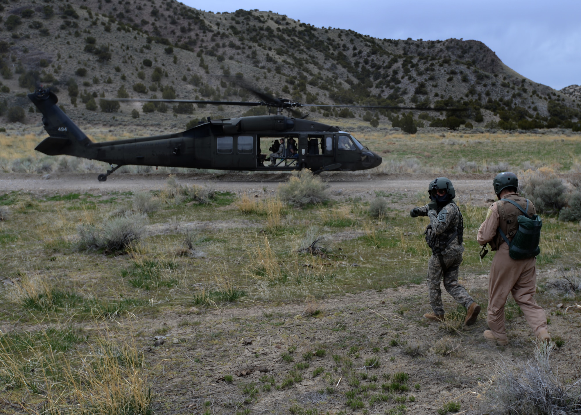 F-16 pilot Lt. Col. Thomas Wolfe (right) is led to a UH-60 Black Hawk by an air crew member during the Lone Survivor exercise near the Utah Test and Training Range April 12. (U.S. Air Force photo/Senior Airman Justyn M. Freeman)