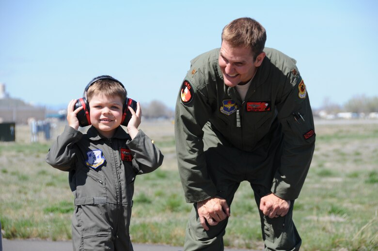 Miles Scott, call sign,“Batkid”, reported for duty at the 173rd Fighter Wing in Klamath Falls, Ore., April 10, 2014. Scott is in remission from leukemia and had the opportunity to be a part of the Fighter Pilot for a Day program hosted by the 114th Fighter Squadron.  He donned a flight suit and helmet and Maj. Richard Giampietri, F-15 instructor pilot, escorted Scott to watch take-offs up close and personal, sit in the cockpit of a jet, and meet the crew chief and other maintenance personnel. (U.S. Air Force photo by Tech. Sgt. Jefferson Thompson/released)