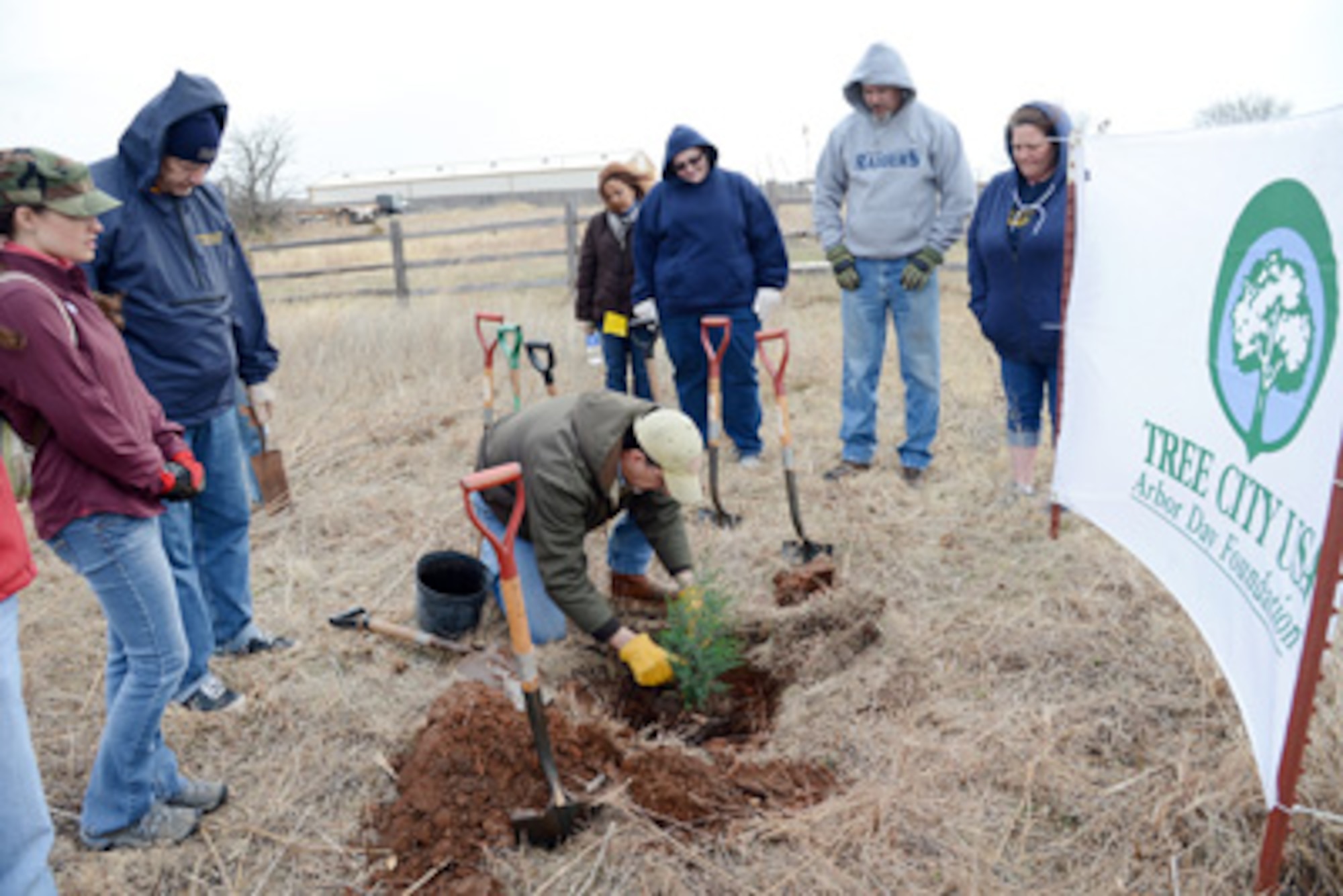 John Krupovage, the Natural Resource manager with the 72nd Civil Engineering Directorate, demonstrates how to correctly plant cedar trees. Members of the Tinker Federal Civic Leaders, a student group with Rose State College, were on hand on Arbor Day to help plant about 50 trees in a section of Tinker’s Urban Greenway. (Air Force photo by Kelly White)