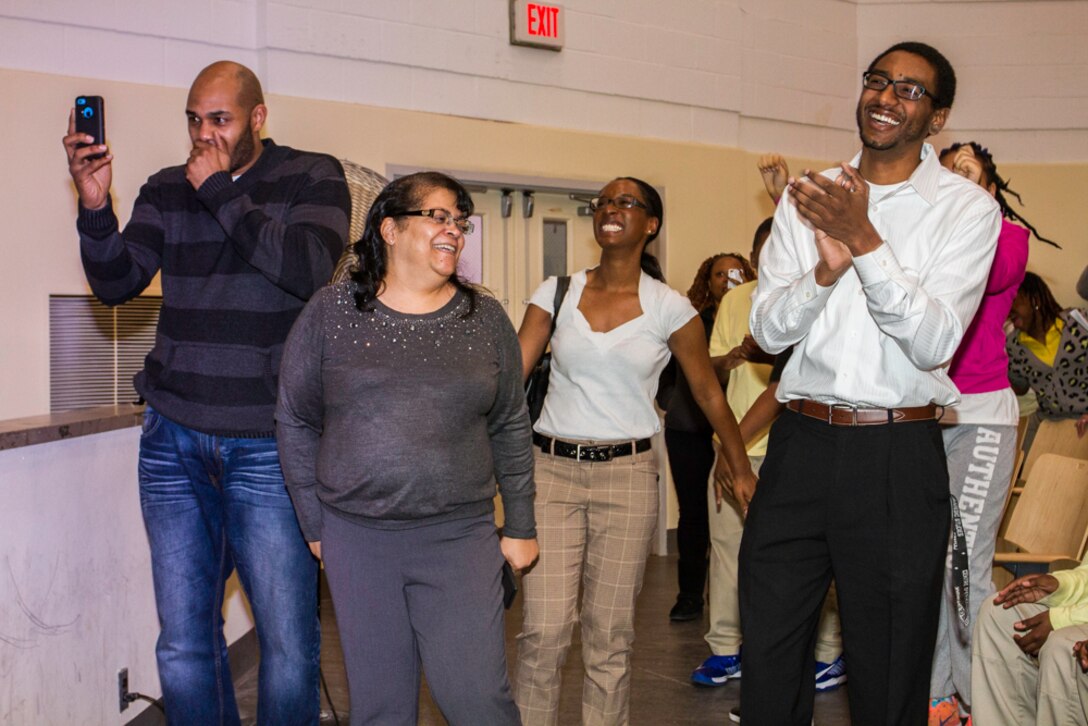 Faculty of Charles Hart Middle School dance, sing, and laugh while watching the school’s principal, Billy Kearney, show his moves on stage during a performance by the U.S. Air Force Band’s Max Impact on March 26, 2014. One of the band’s vocalists invited all faculty to the front of the auditorium for a “dance off.”  Kearney, the clear winner, said, “Sometimes you’ve got to let them see you’re real.” (U.S. Navy photo by Lt. Cmdr. Jim Remington)