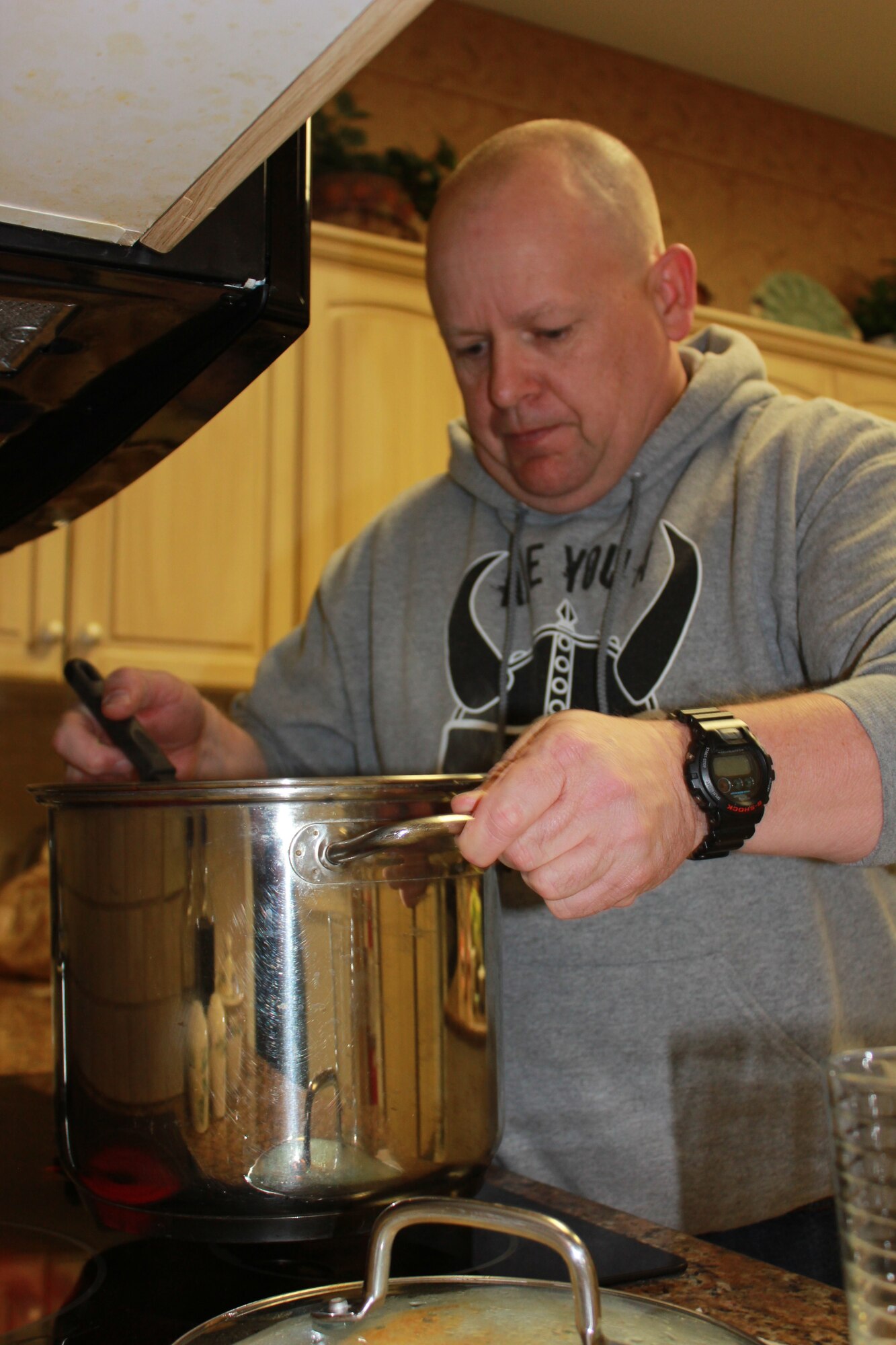 Tech. Sgt. Richard Grybos, Buckley 5/6 Association president and Air Reserve Personnel Center recognition service team technician, helps prepare meals at the Denver Fisher House Feb. 10, 2014. (U.S. Air Force photo/Tech. Sgt. Rob Hazelett)