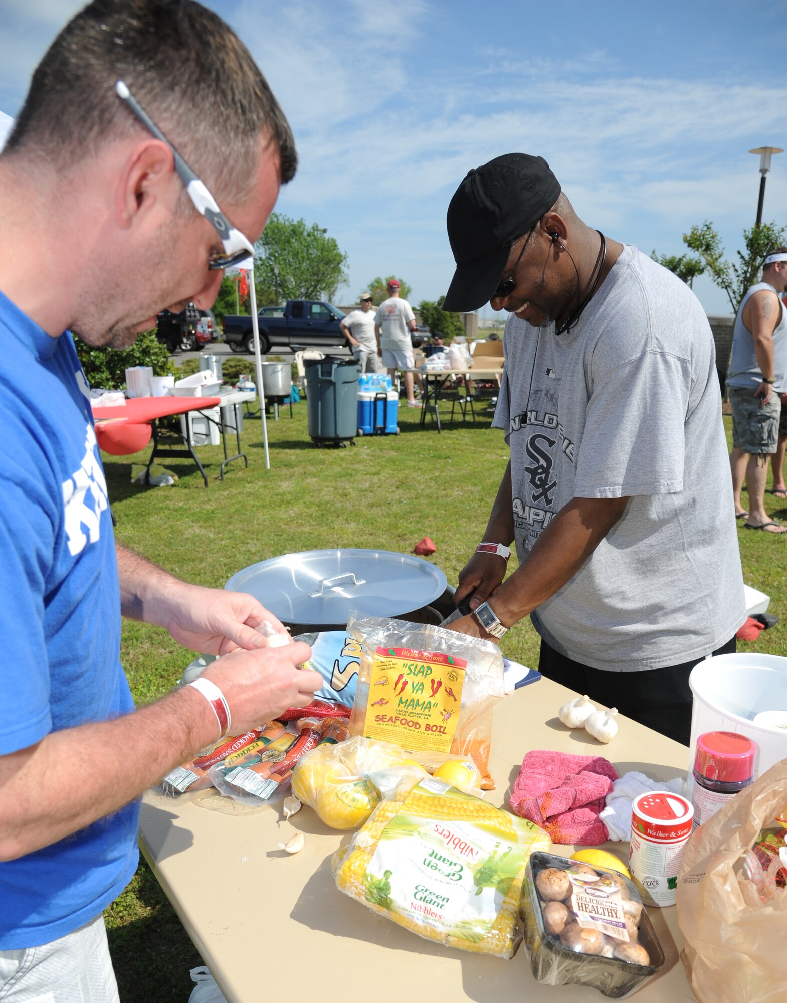 Tech. Sgt. Jason McAlpin and Curtis Rucker, 334th Training Squadron, prepares the ‘fixins’ to accompany their crawfish during the 2nd Annual Bay Breeze Crawfish Cook-Off April 11, 2014, at the Bay Breeze Event Center, Keesler Air Force Base, Miss.   The trophy was taken by the “Cajun Snappa” team, who will receive a free entry into the 22nd Annual Mississippi Coast Coliseum Crawfish Festival Cook-Off.  (U.S. Air Force photo by Kemberly Groue)