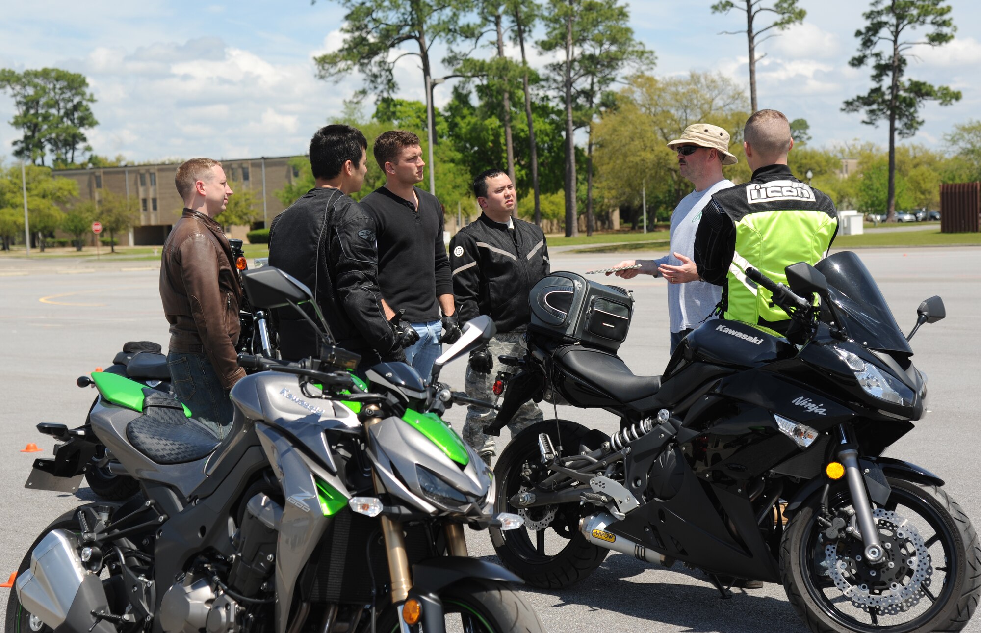 Tech. Sgt. Michael Farmer, 81st Training Support Squadron and motorcycle safety course instructor, (wearing hat), gives driving instruction to students during the motorcycle safety course April 11, 2014, at Keesler Air Force Base, Miss.  The course is offered twice a month and teaches students the basic operating skills and safety rules for riding a motorcycle.  (U.S. Air Force photo by Kemberly Groue)