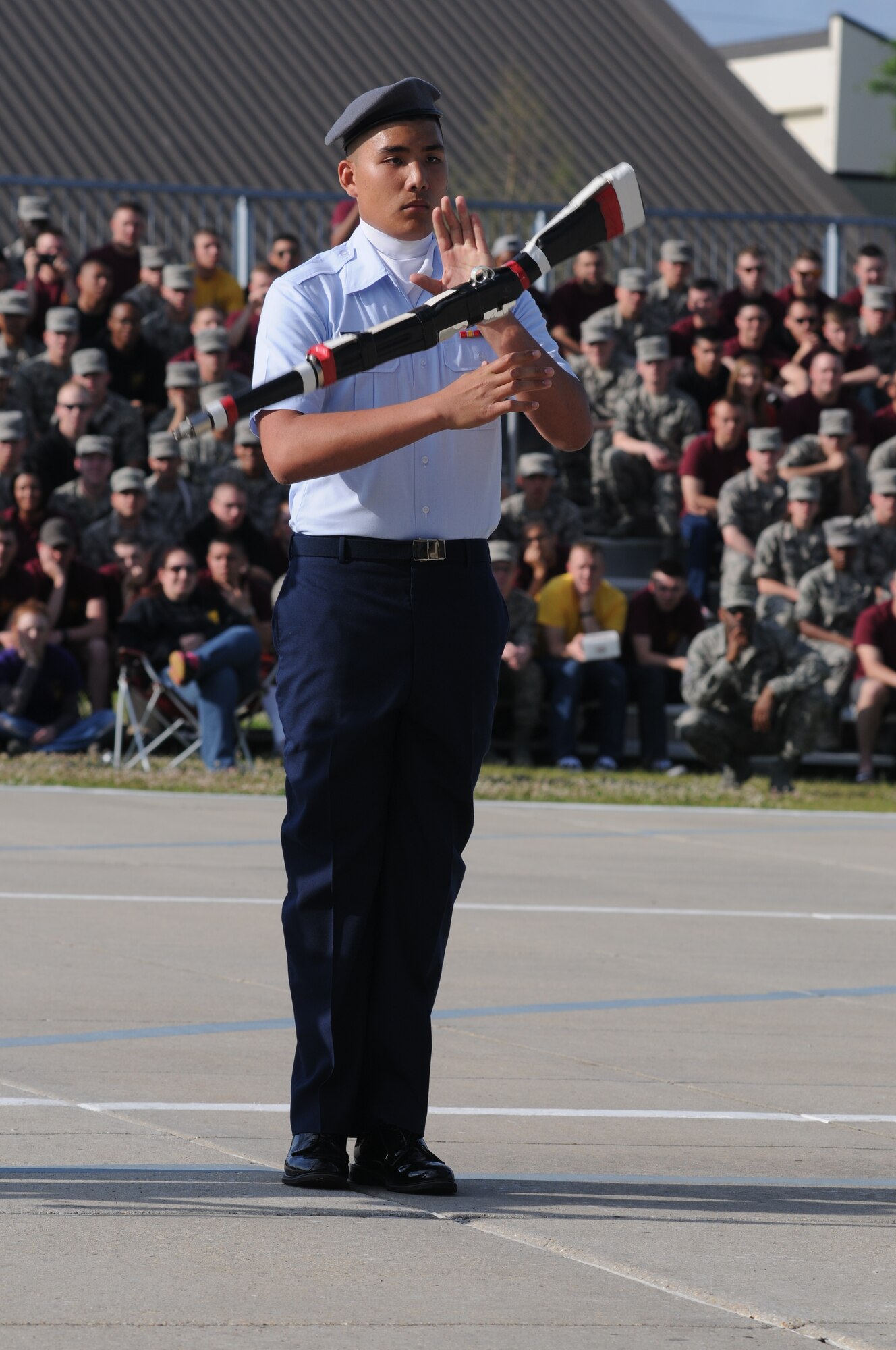 Airman Basic, James Lee, 335th Training Squadron, spins his weapon during the freestyle performance at the 81st Training Group’s drill down competition April 11, 2014, behind the Levitow Training Support Facility, Keesler Air Force Base, Miss.  The 335th TRS placed 1st in regulation and 2nd in open ranks and freestyle.  (U.S. Air Force photo by Kemberly Groue)