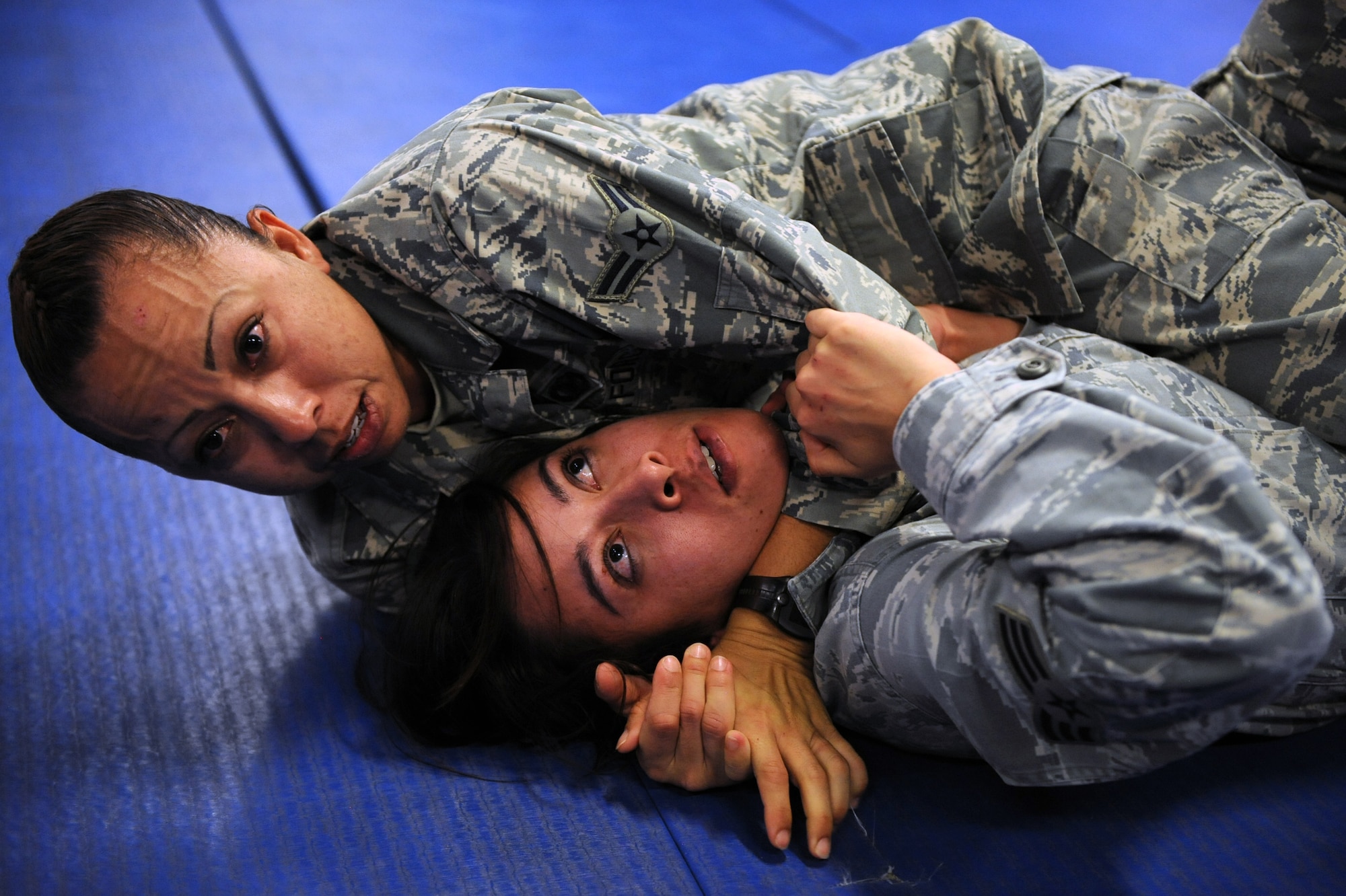It’s just business….nothing personal. Airman 1st Class Anna Solis applies a free-style stranglehold on Senior Airman Jessica Switzer on March 21 at the Western Army National Guard Aviation Training Site gym in Marana, Ariz. The two security forces specialists were part of an intense 5-day, Army National Guard-instructed training event titled Basic Combative Course. (U.S. Air Force Photo by Airman 1st Class Chris Drzazgowski/Released)