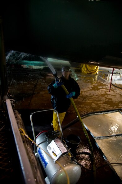 A crew chief from the 5th Aircraft Maintenance Squadron washes a B-52H Stratofortress at Minot Air Force Base, N.D., March 10, 2014. The B-52s are routinely washed every 180 days to prevent corrosion and every 30 days in high corrosion areas. (U.S. Air Force photo/Senior Airman Brittany Y. Auld)