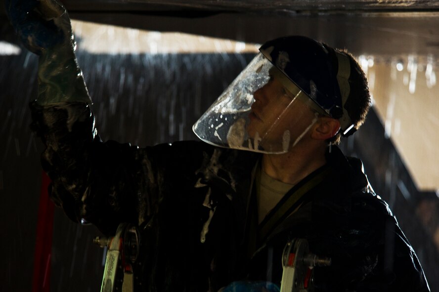 Airman 1st Class Daniel Starr, 5th Aircraft Maintenance Squadron crew chief, scrubs the wing of a B-52H Stratofortress at Minot Air Force Base, N.D., March 10, 2014. The B-52s are routinely washed every 180 days to prevent corrosion and every 30 days in high corrosion areas. (U.S. Air Force photo/Senior Airman Brittany Y. Auld)