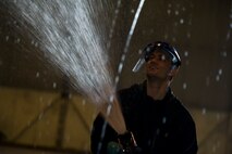 A crew chief from the 5th Aircraft Maintenance Squadron washes a B-52H Stratofortress at Minot Air Force Base, N.D., March 10, 2014. The B-52s are routinely washed every 180 days to prevent corrosion and every 30 days in high corrosion areas. (U.S. Air Force photo/Senior Airman Brittany Y. Auld)