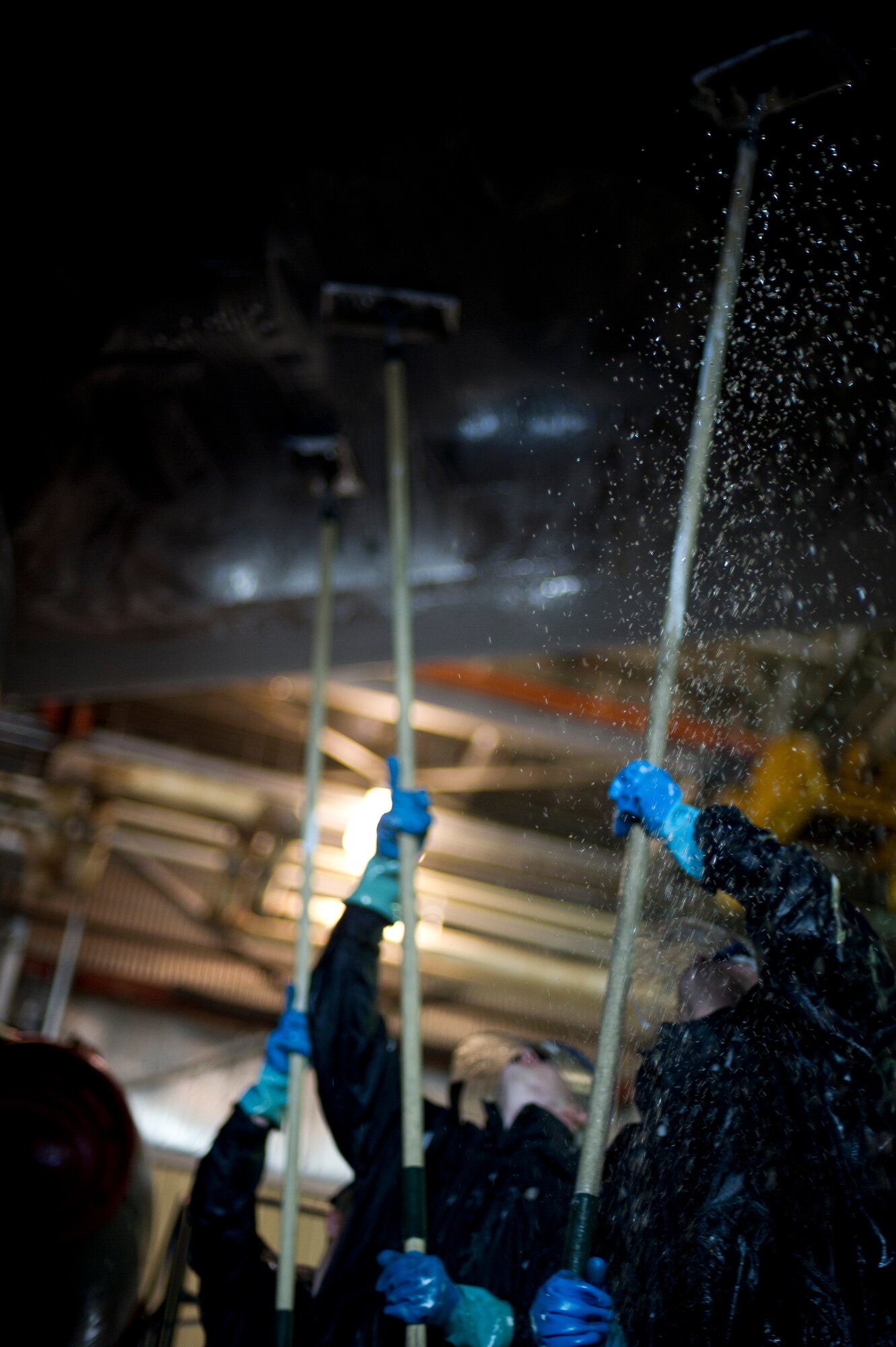 Crew chiefs from the 5th Aircraft Maintenance Squadron wash a B-52H Stratofortress at Minot Air Force Base, N.D., March 10, 2014. The B-52s are routinely washed every 180 days to prevent corrosion and every 30 days in high corrosion areas.  After the wash is completed, post wash lube is used to force water and collected dirt out of high friction and moving areas. This keeps the parts functioning properly for safety during flights. (U.S. Air Force photo/Senior Airman Brittany Y. Auld)
