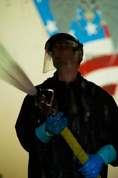 Crew chiefs from the 5th Aircraft Maintenance Squadron wash a B-52H Stratofortress at Minot Air Force Base, N.D., March 10, 2014. The B-52s are routinely washed every 180 days to prevent corrosion and every 30 days in high corrosion areas.  After the wash is completed, post wash lube is used to force water and collected dirt out of high friction and moving areas. This keeps the parts functioning properly for safety during flights. (U.S. Air Force photo/Senior Airman Brittany Y. Auld)