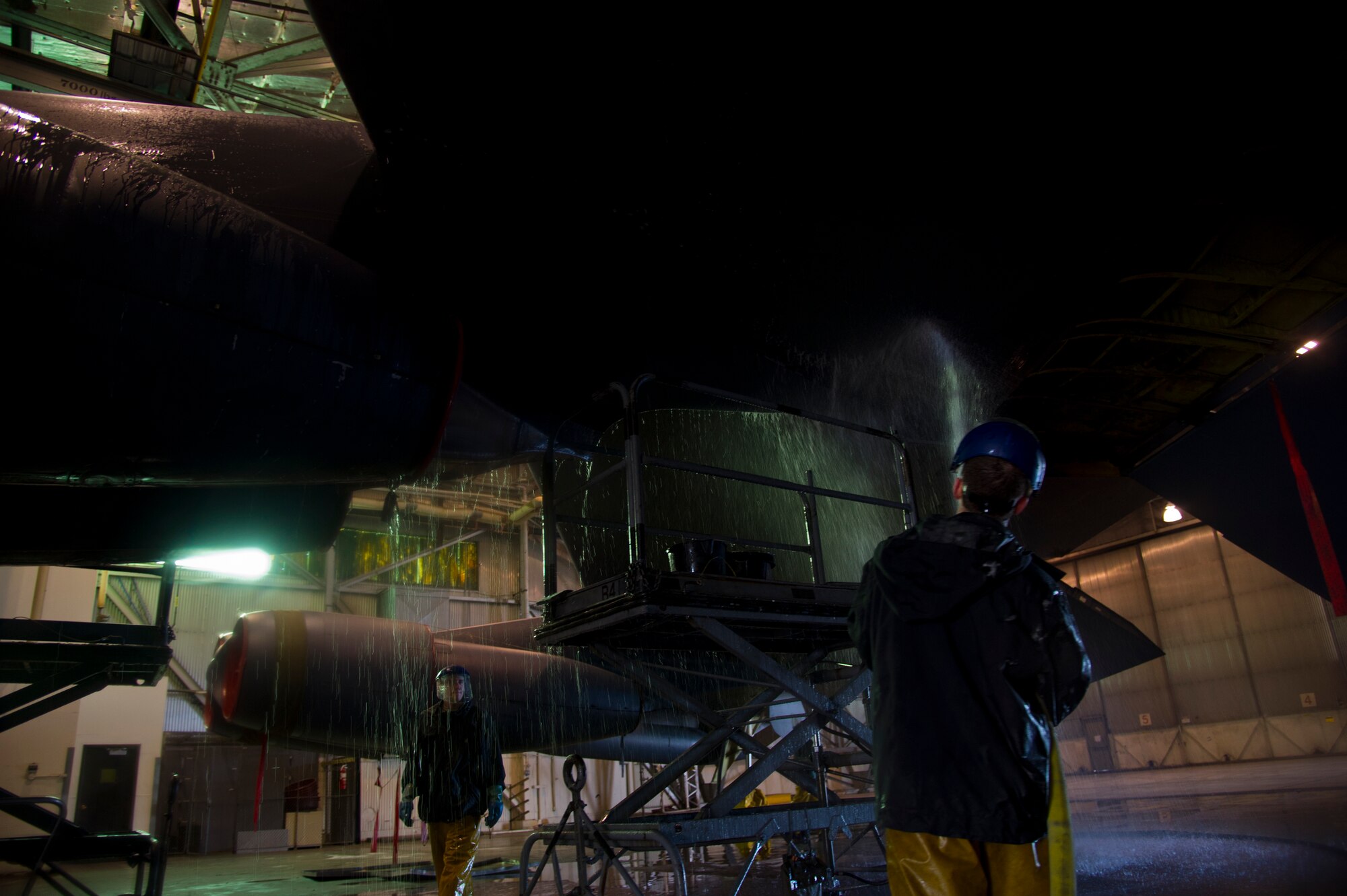 Crew chiefs from the 5th Aircraft Maintenance Squadron wash a B-52H Stratofortress at Minot Air Force Base, N.D., March 10, 2014. The B-52s are routinely washed every 180 days to prevent corrosion and every 30 days in high corrosion areas.  After the wash is completed, post wash lube is used to force water and collected dirt out of high friction and moving areas. This keeps the parts functioning properly for safety during flights. (U.S. Air Force photo/Senior Airman Brittany Y. Auld)
