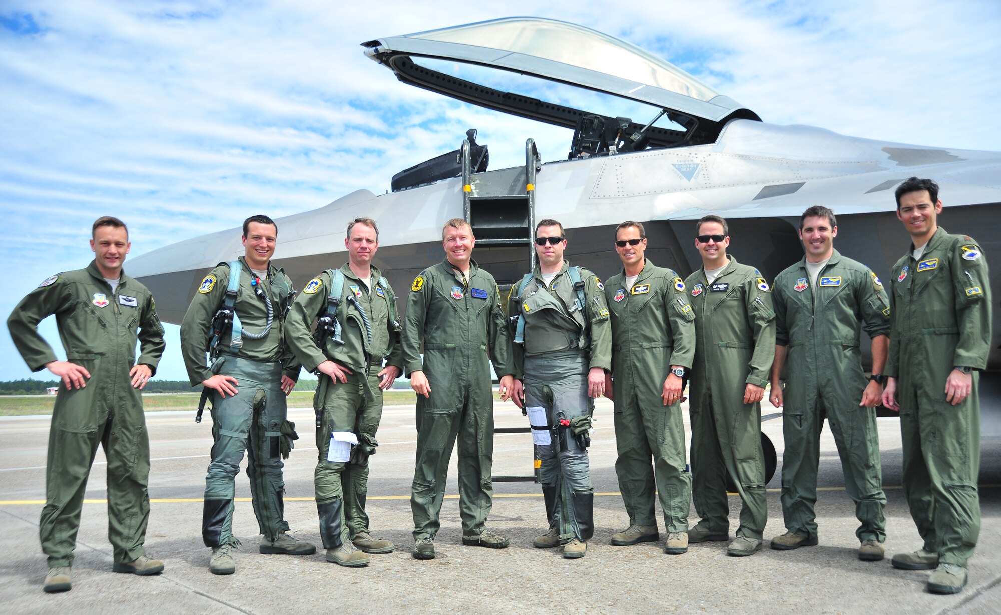 95th Fighter Squadron Airmen and 7th Fighter Squadron Airmen from Holloman Air Force Base, N.M., take a group shot April 8 at the Tyndall flight line. Both units worked together to get the last four F-22 Raptors from Holloman to Tyndall. (U.S. Air Force photo by Airman 1st Class Sergio A. Gamboa)