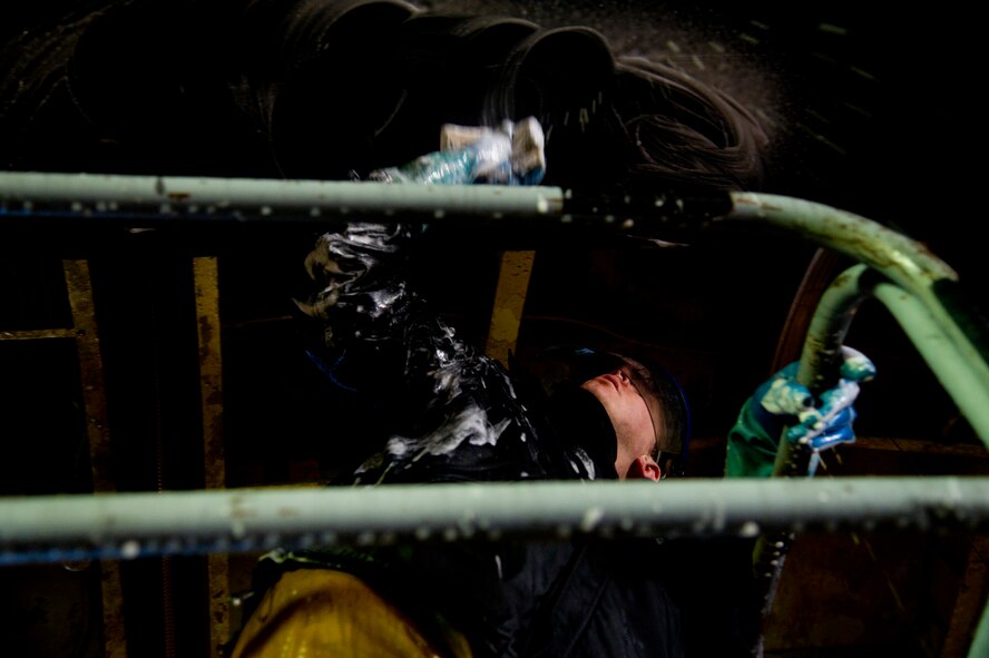 Airman 1st Class Daniel Starr, 5th Aircraft Maintenance Squadron crew chief, scrubs the wing of a B-52H Stratofortress at Minot Air Force Base, N.D., March 10, 2014. The B-52s are routinely washed every 180 days to prevent corrosion and every 30 days in high corrosion areas. (U.S. Air Force photo/Senior Airman Brittany Y. Auld)