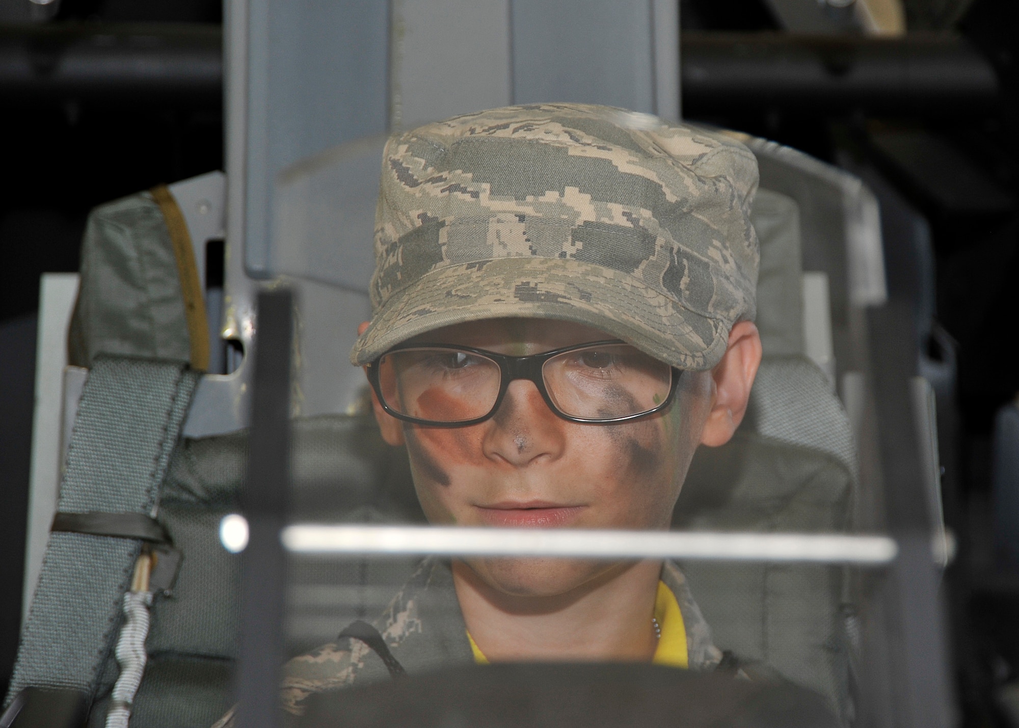 A Jr. Raptor sits inside of an aircraft’s cockpit April 12 at Tyndall’s Hangar 5. The Jr. Raptor program allows military children to experience what their parents would go through for a deployment. (U.S. Air Force photo by Airman 1st Class Solomon Cook)