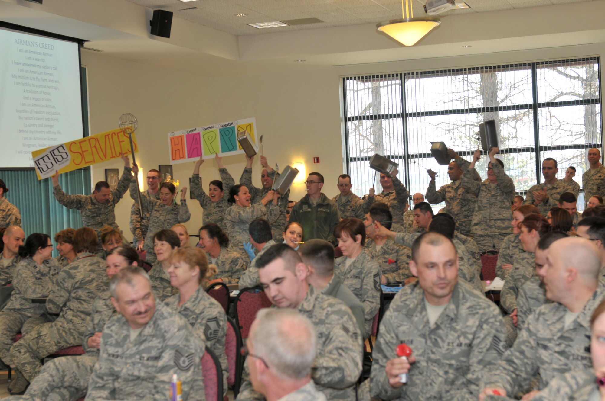 STRATTON AIR NATIONAL GUARD BASE, N.Y. -- Airmen of the 109th Force Support Squadron celebrate after Chief Master Sgt. Richard King, New York Air National Guard command chief, named them the winner of the promotion recognition ceremony spirit stick on April 6, 2014. Airmen throughout the 109th Airlift Wing gathered to cheer on their peers who were being promoted during the ceremony. (Air Natiional Guard photo by Staff Sgt. Benjamin German/Released)