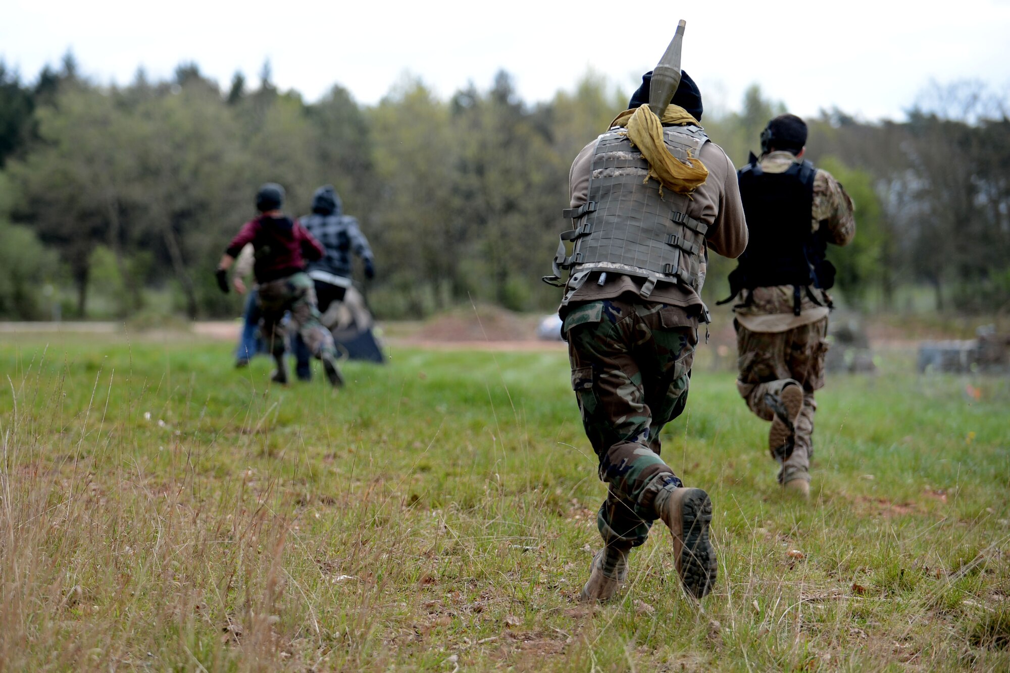 U.S. Air Force Airmen simulate a hostile attack during a combat readiness training course at Spangdahlem Air Base, Germany, April 15, 2014. CRT is a course that is conducted in a realistic environment to ensure Airmen maintain the highest levels of proficiencies and readiness for worldwide deployments. (U.S. Air Force photo by Airman 1st Class Kyle Gese/Released)