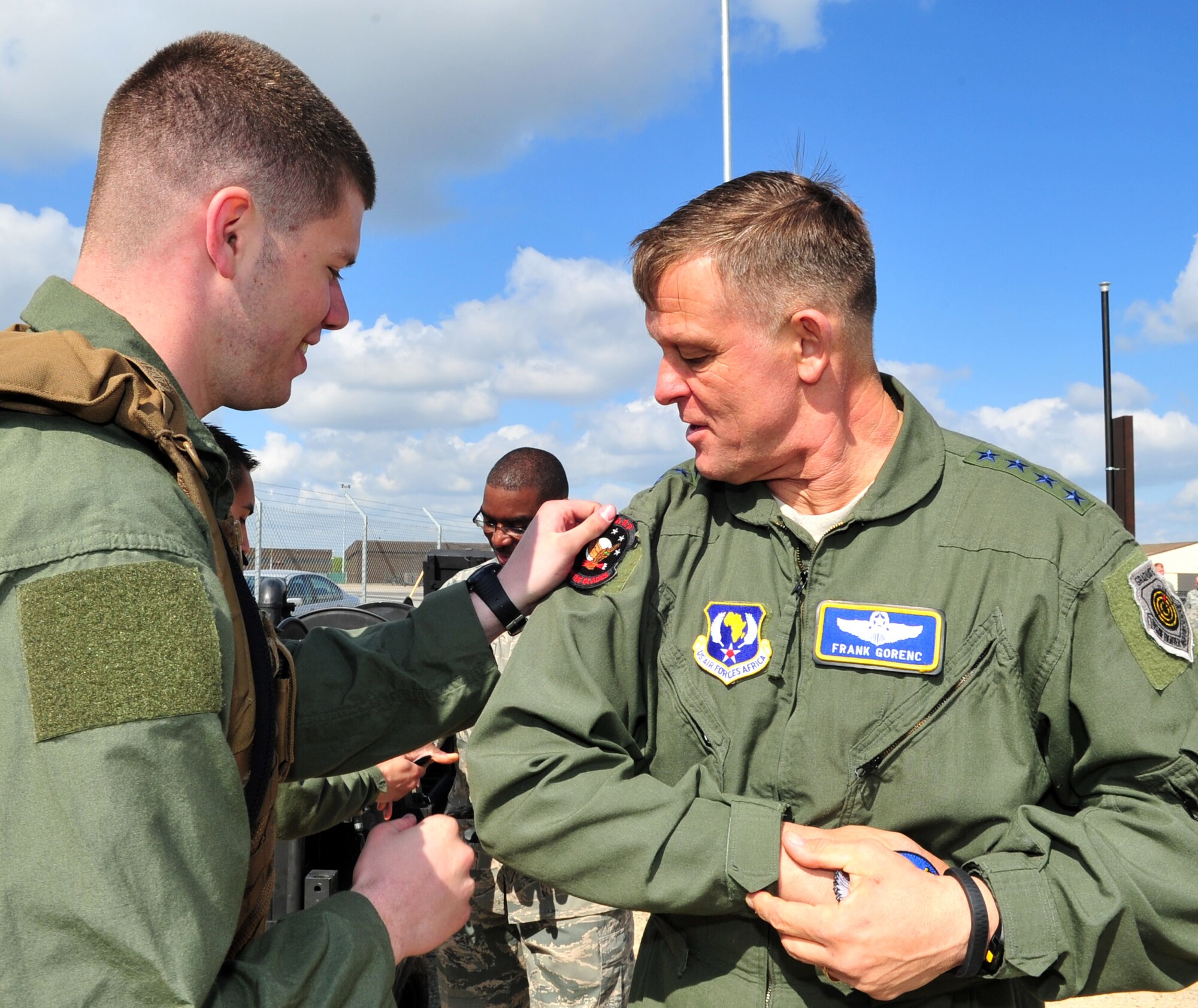 U.S. Air Force Airman 1st Class Thomas Mahoney, left, 100th Logistics Readiness Squadron Forward Area Refueling Point operator, presents his FARP patch to U.S. Air Force Gen. Frank Gorenc, U.S. Air Forces in Europe and Air Forces Africa commander, April 14, 2014, during a visit to RAF Mildenhall, England. The general had the opportunity to view some of the FARP equipment during his visit to the base.  The 100th LRS FARP has the largest area of responsibility in the Air Force. (U.S. Air Force photo by Staff Sgt. Krystie Martinez/Released)